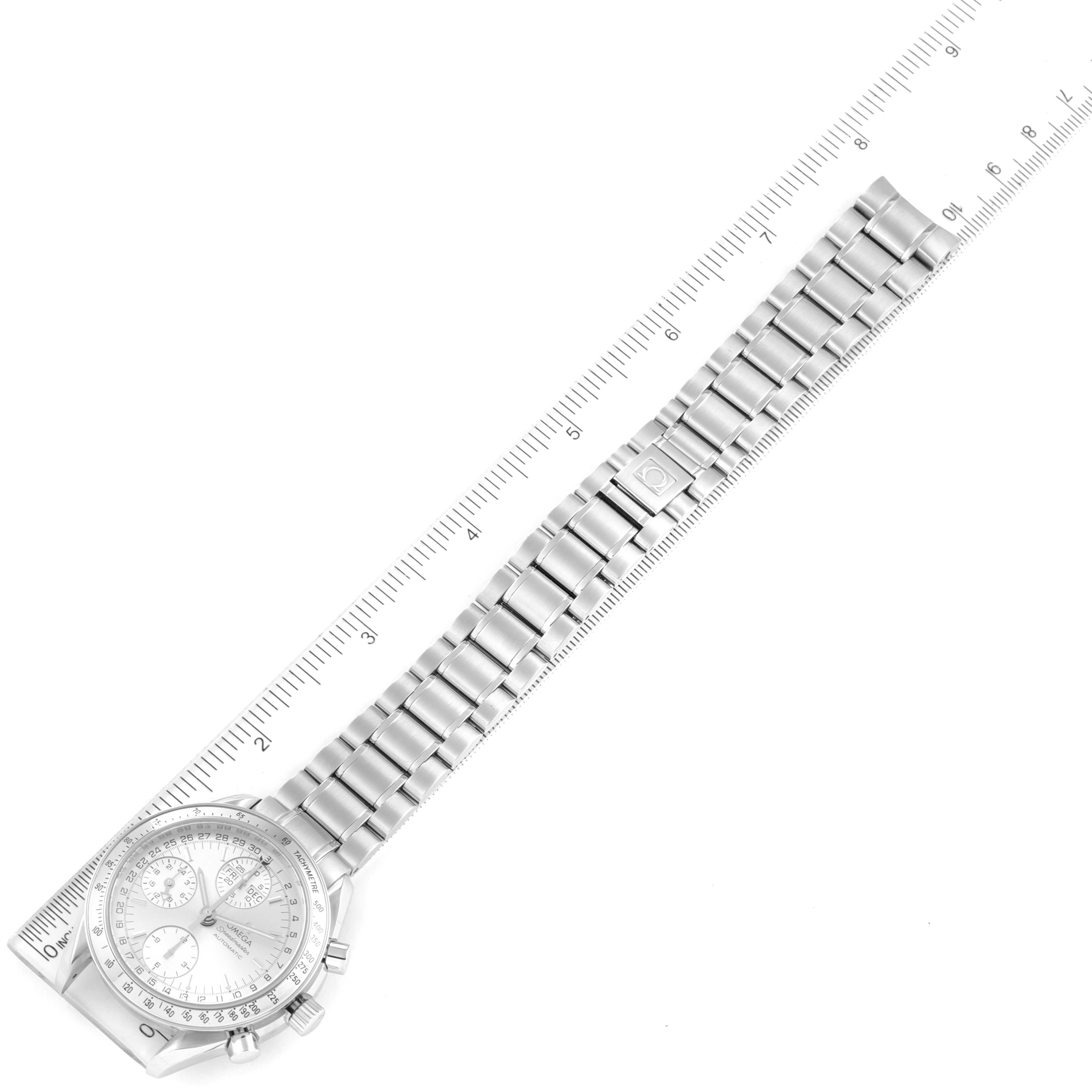 The image shows a top-down view of the Omega Speedmaster 3523.30.00 Men's Stainless Steel Silver Dial 3523.30.00 Men's Stainless Steel Silver Dial watch, highlighting its face, bezel, and metal bracelet with a ruler beside it.