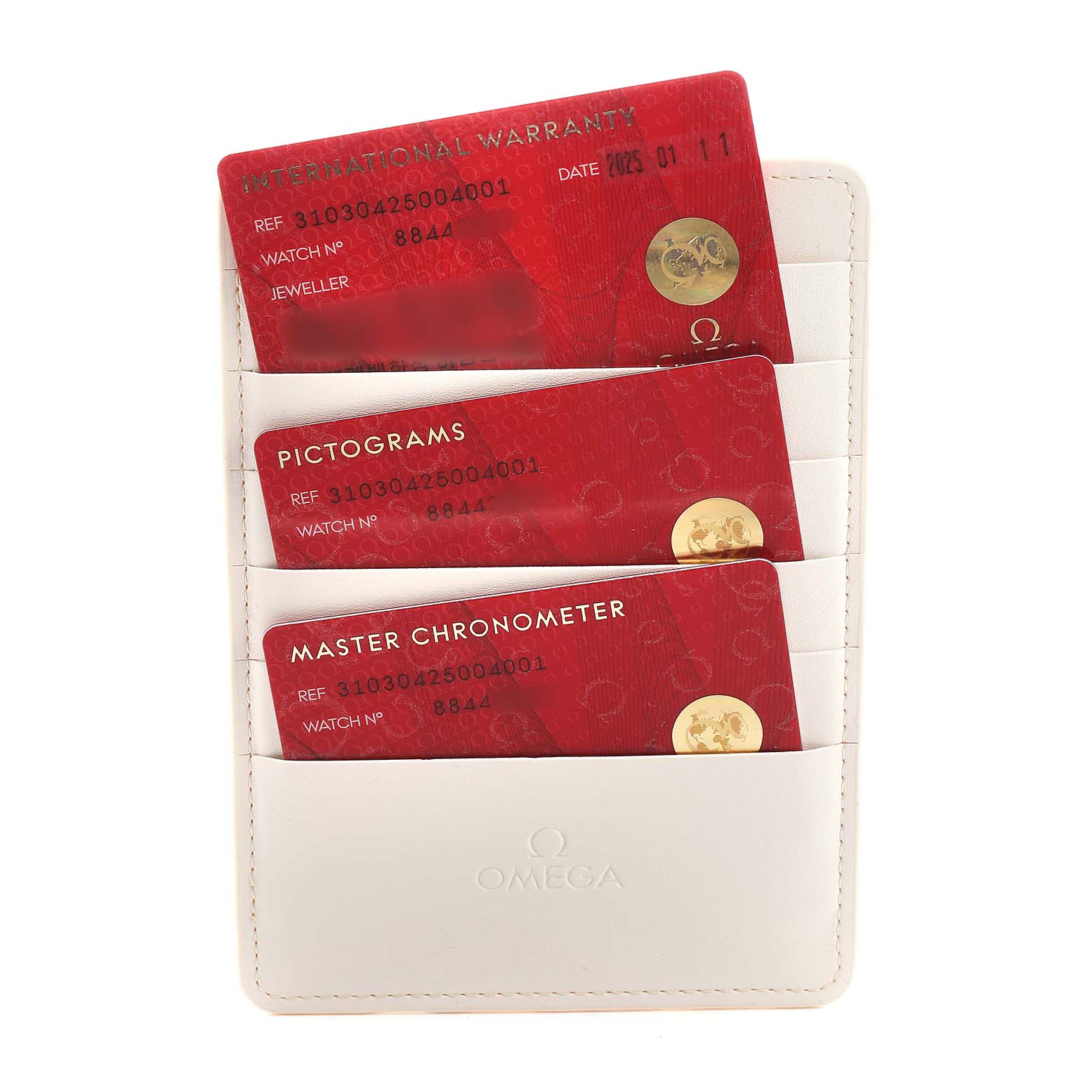 The image shows Omega Speedmaster 310.30.42.50.04.001 Men's Stainless Steel White Dial watch accessories, including warranty and chronometer cards in a holder.