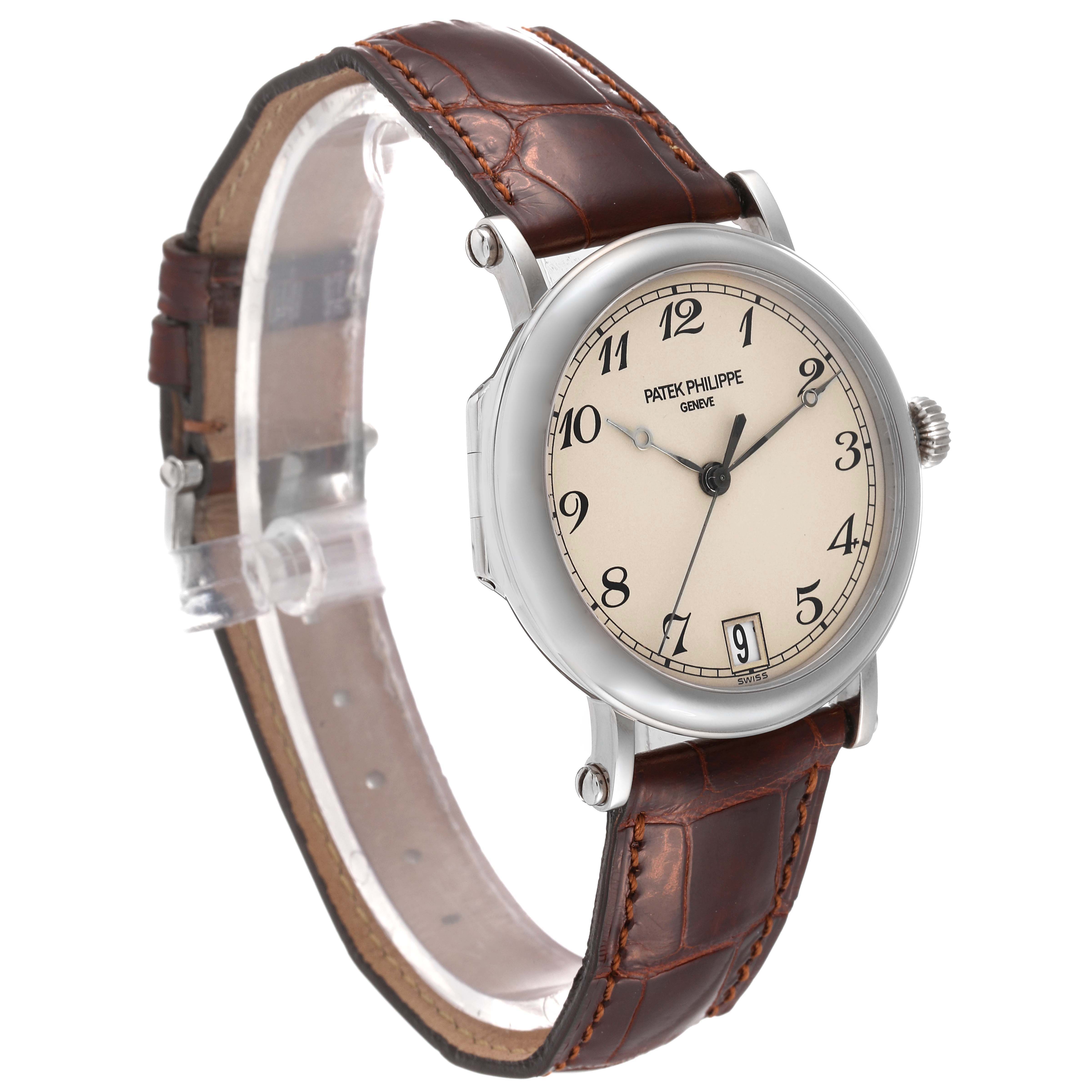 This image shows a side angle of a Patek Philippe Calatrava 5053 Men's White Gold Beige Dial 5053 Men's White Gold Beige Dial watch with a brown leather strap and cream-colored dial.