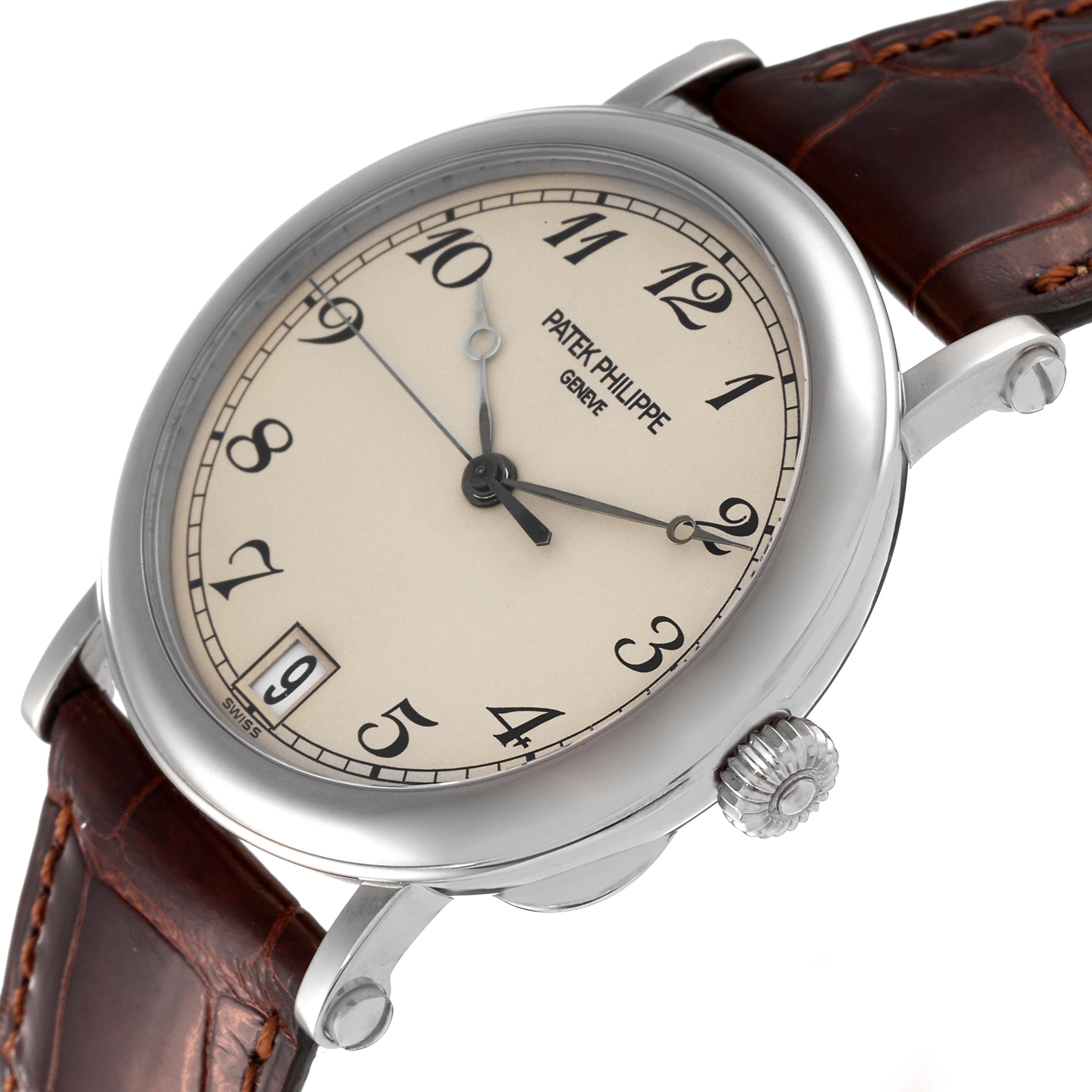 This image shows a side angle of the Patek Philippe Calatrava 5053 Men's White Gold Beige Dial 5053 Men's White Gold Beige Dial watch, highlighting the face, crown, and brown leather strap.