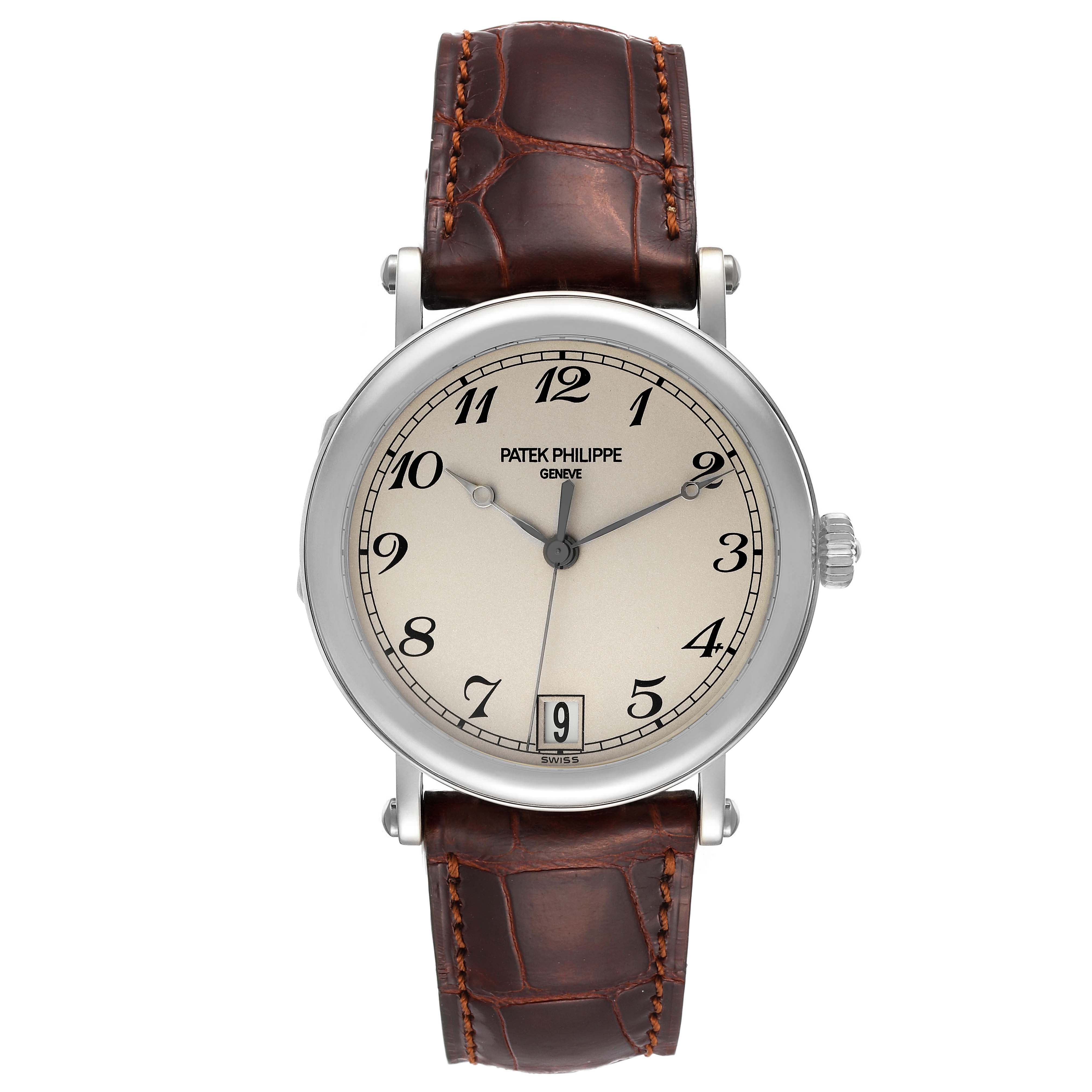 The image shows a front view of a Patek Philippe Calatrava 5053 Men's White Gold Beige Dial 5053 Men's White Gold Beige Dial watch with a brown leather strap and a silver dial.