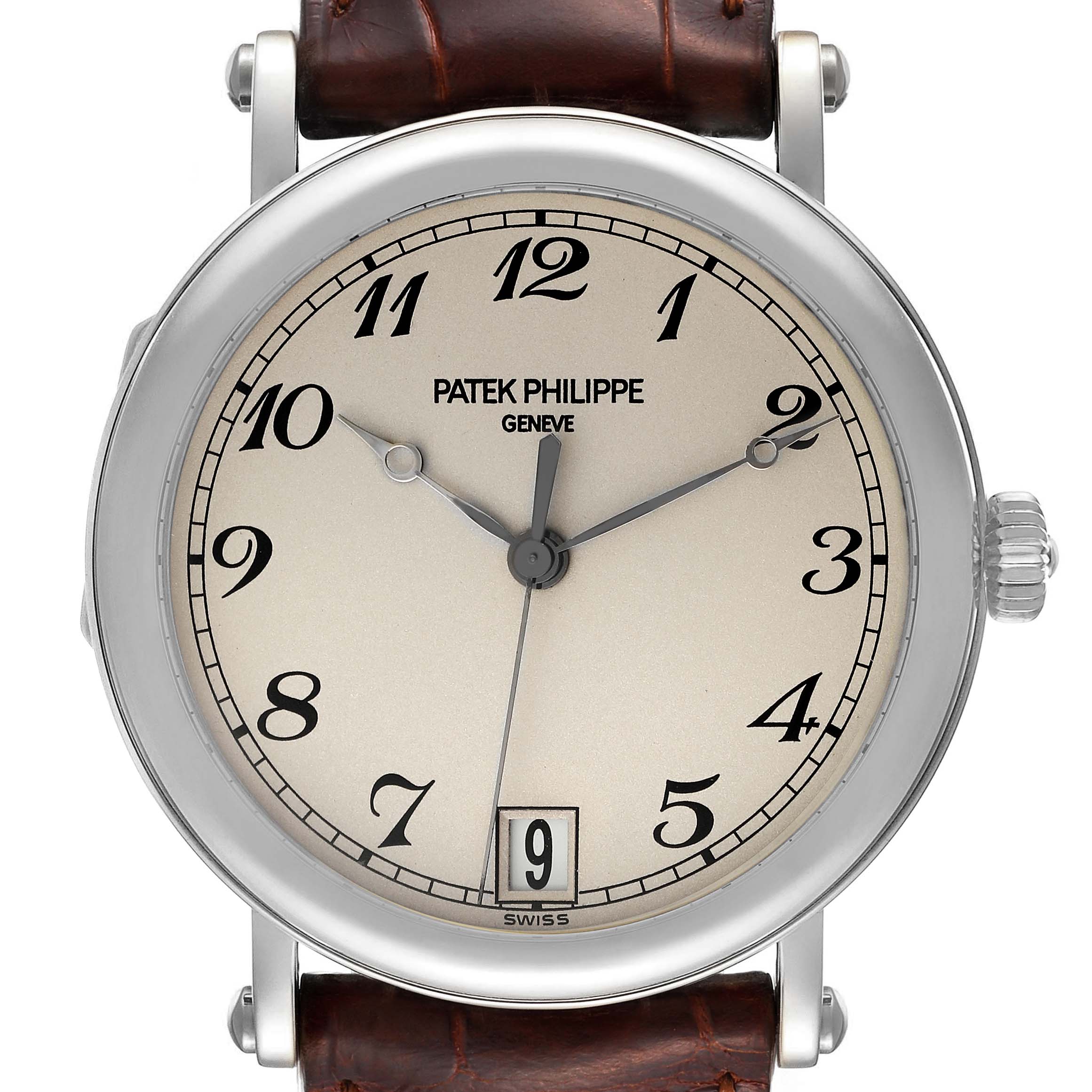 The image shows a front view of a Patek Philippe Calatrava 5053 Men's White Gold Beige Dial 5053 Men's White Gold Beige Dial watch, displaying its face, numbers, and part of the leather strap.