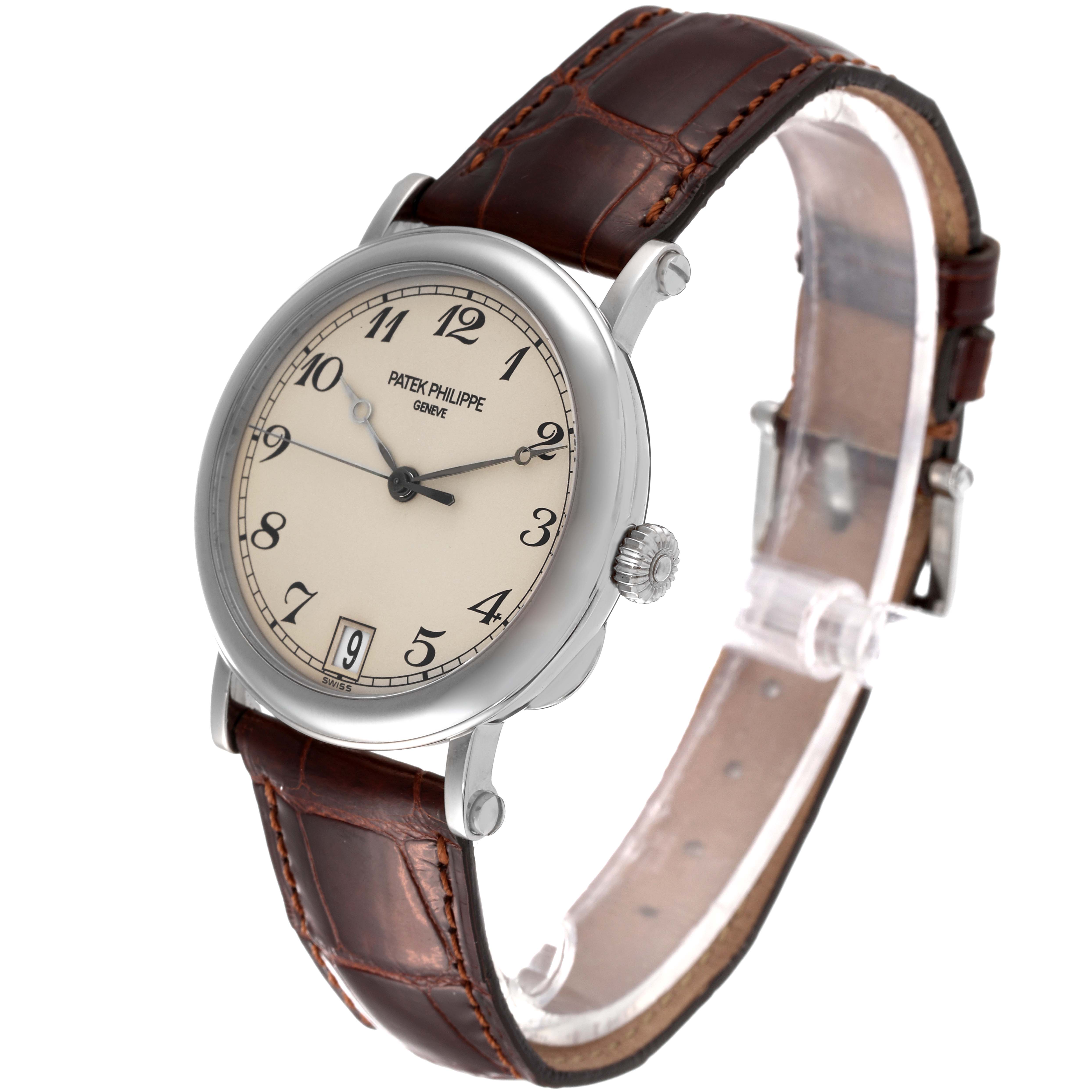 This image shows a side angle view of a Patek Philippe Calatrava 5053 Men's White Gold Beige Dial 5053 Men's White Gold Beige Dial watch, highlighting its cream dial, leather strap, and crown.