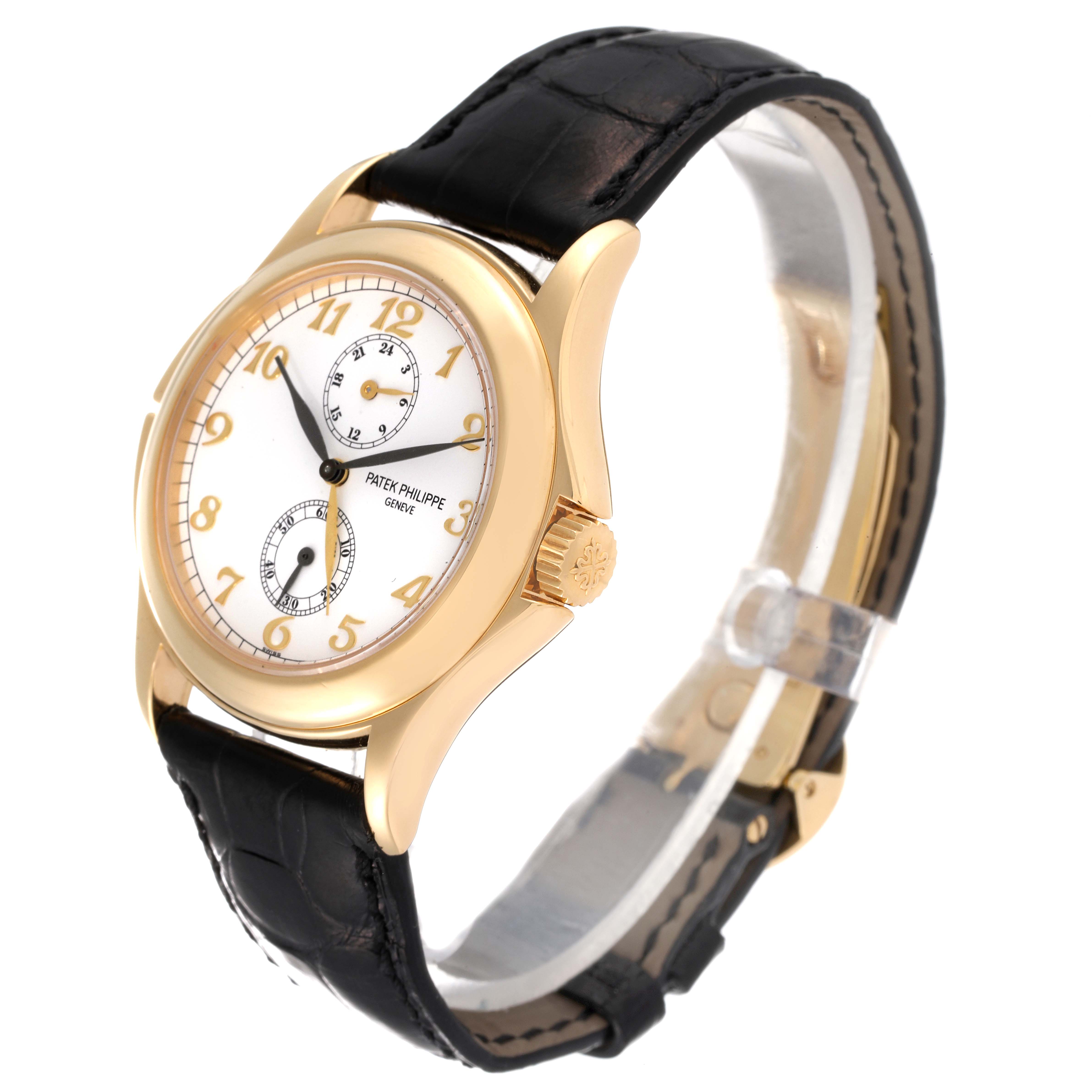 This image shows a Patek Philippe Calatrava 5134J Men
s Yellow Gold White Dial 5134J Men
s Yellow Gold White Dial watch angled to display the face, crown, and part of the leather strap.