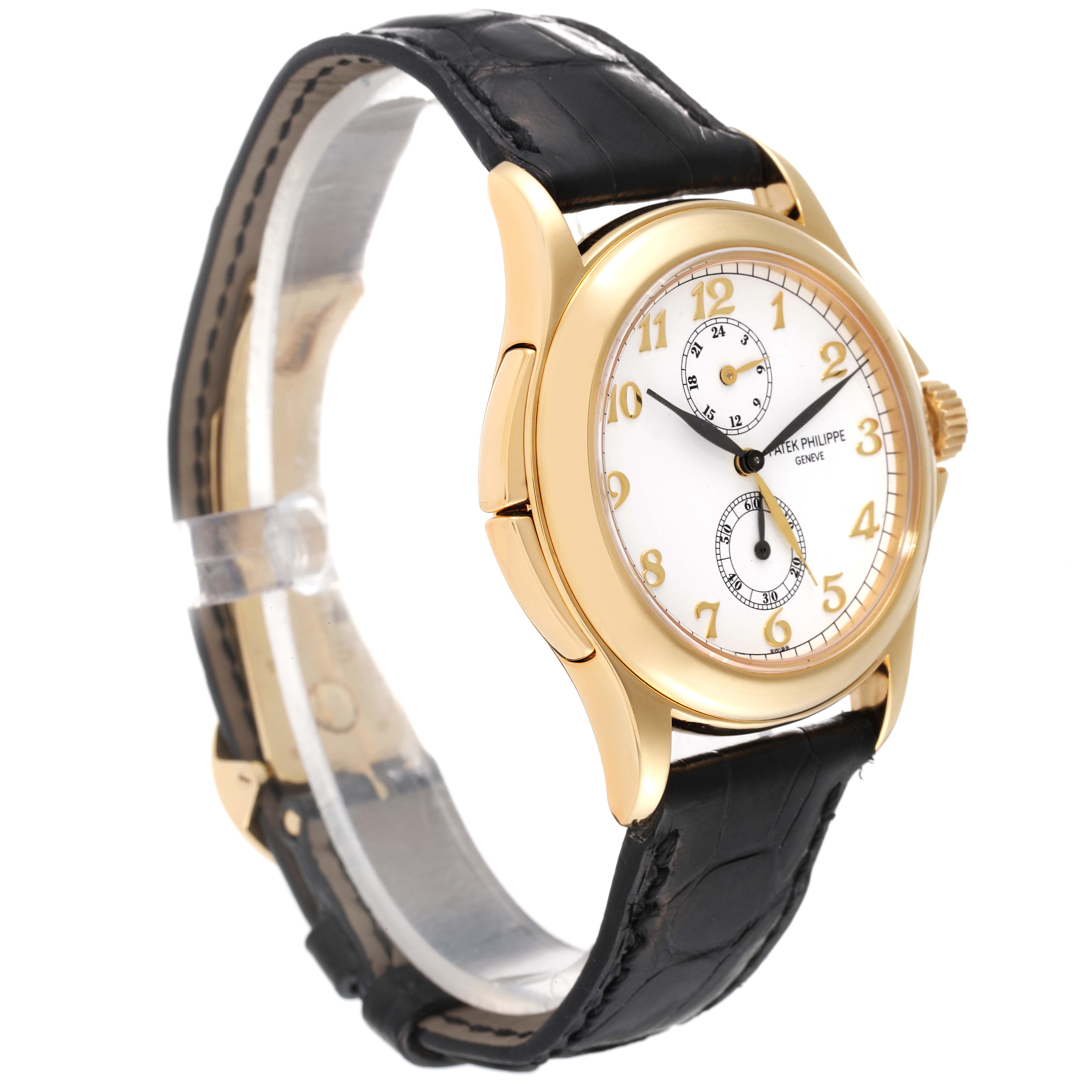 The image shows a Patek Philippe Calatrava 5134J Men
s Yellow Gold White Dial 5134J Men
s Yellow Gold White Dial watch at a slight angle, highlighting its gold case, white dial, and black leather strap.