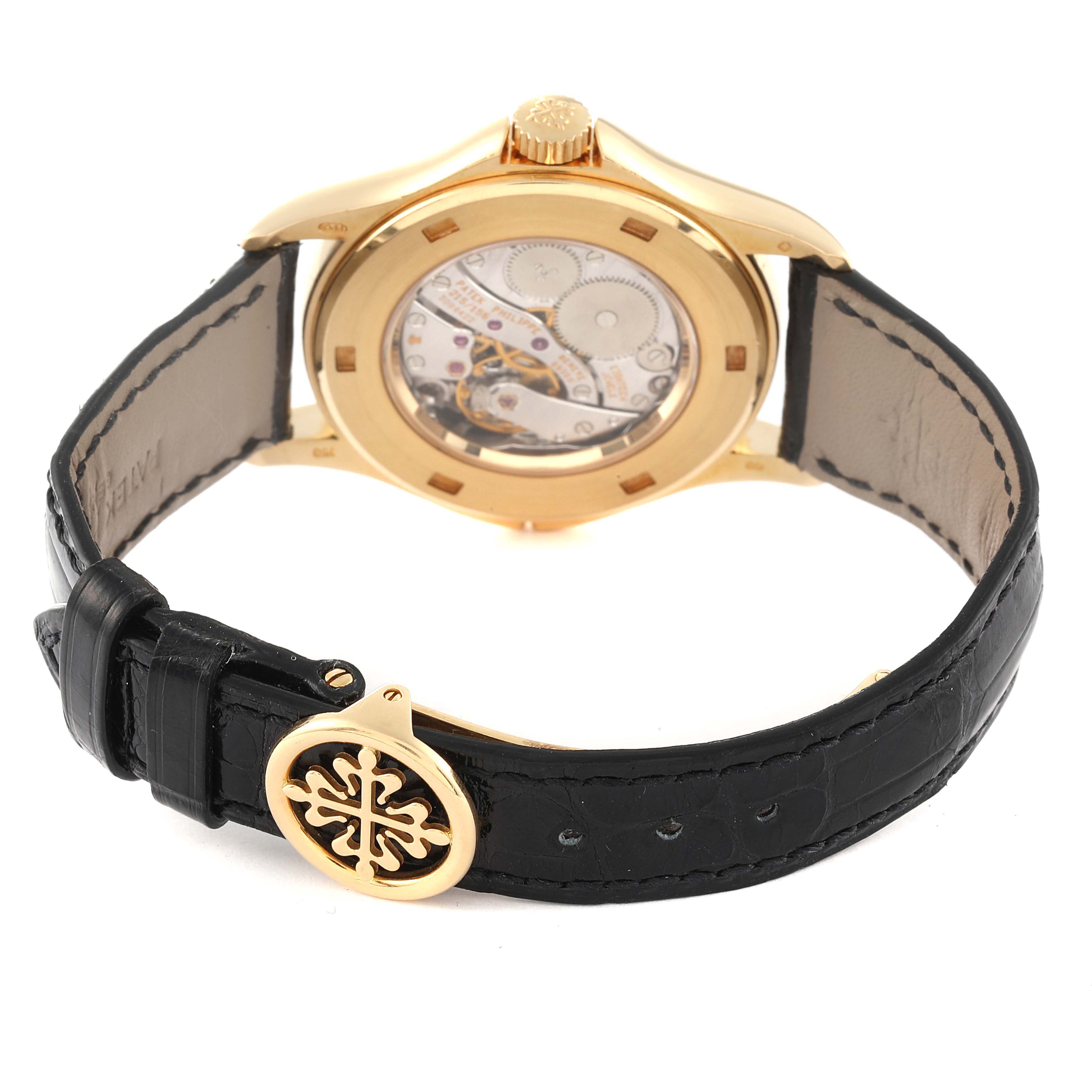 This image shows the back view of a Patek Philippe Calatrava 5134J Men
s Yellow Gold White Dial 5134J Men
s Yellow Gold White Dial watch, highlighting its movement and leather strap with a branded buckle.