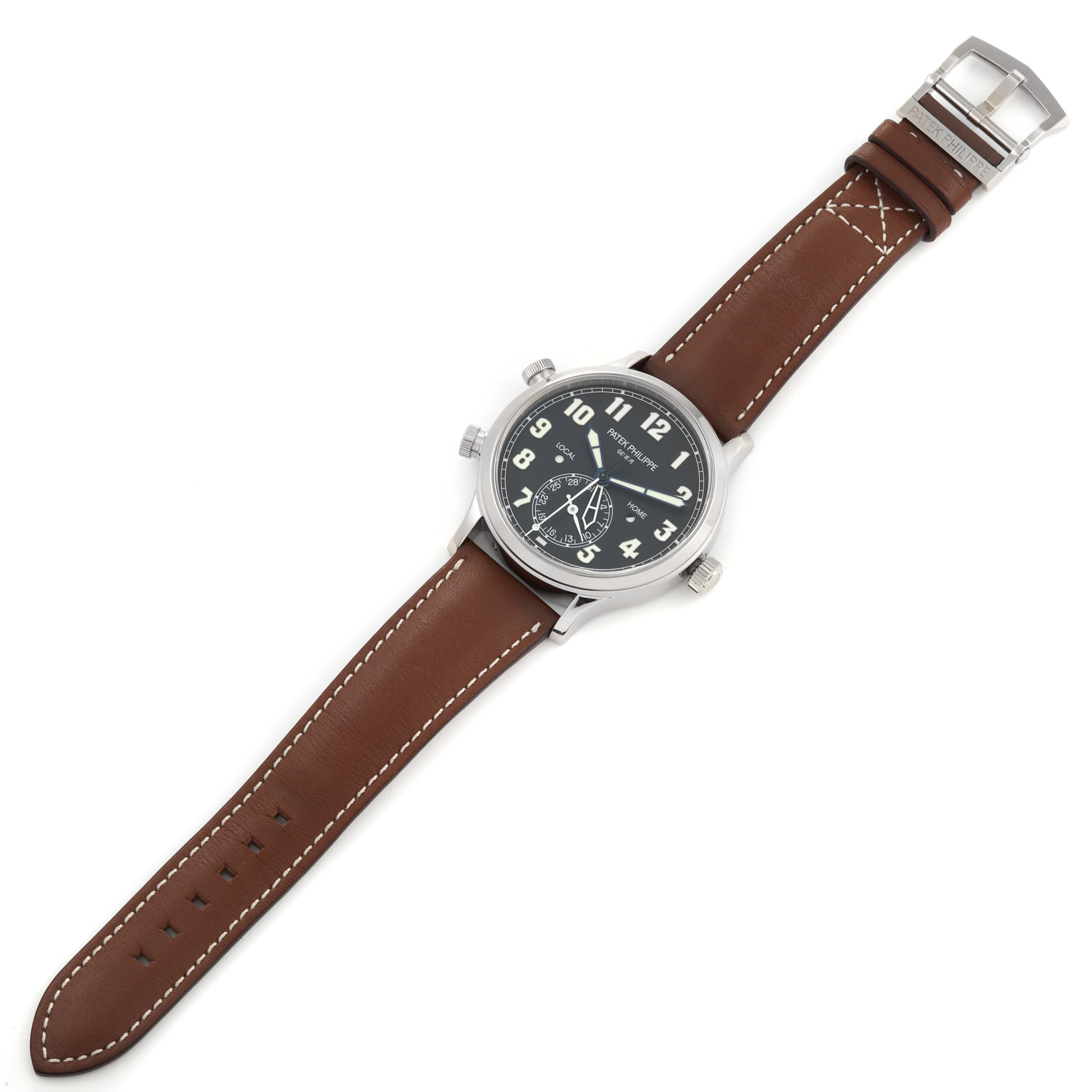 The image shows a Patek Philippe Calatrava 5524G-001 Men's White Gold Black Dial 5524G-001 Men's White Gold Black Dial watch from a top-down angle, displaying its brown leather strap and black dial.