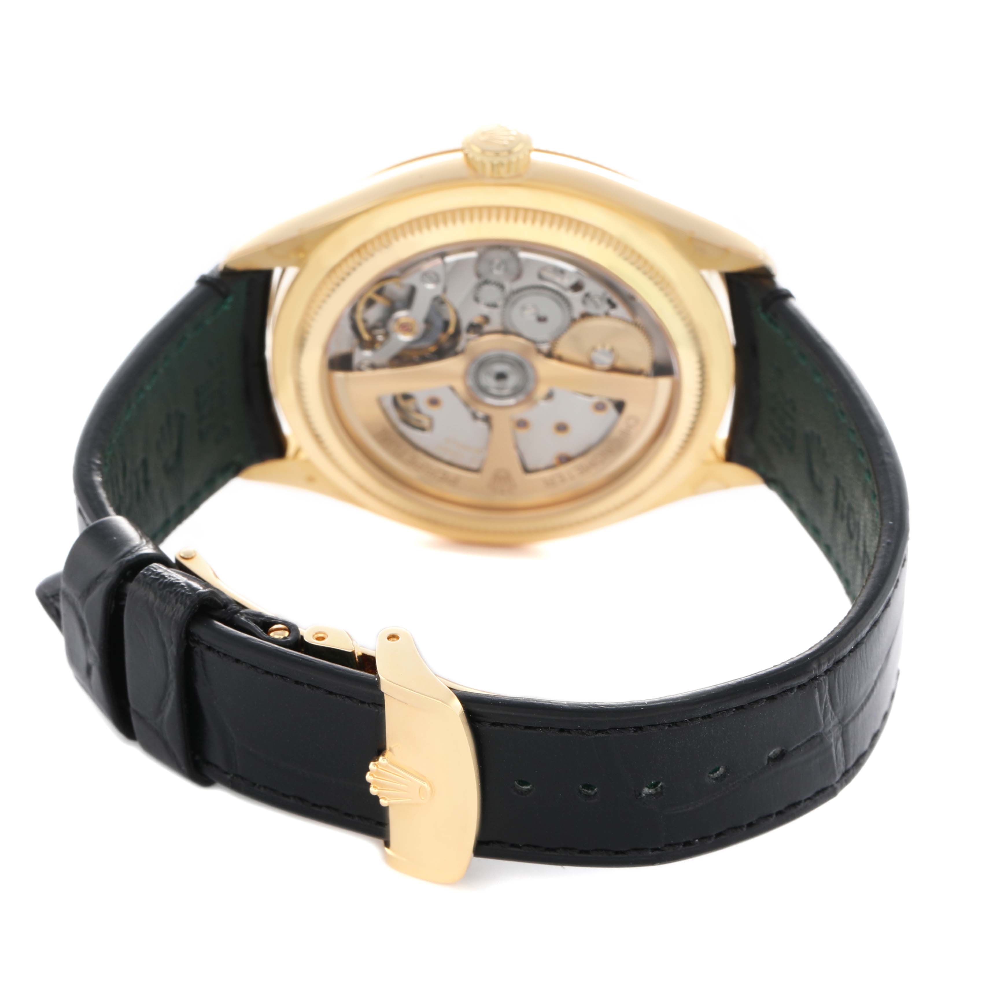 The Rolex 1908 52508 Men's Yellow Gold Black Dial model is shown from the back, revealing its movement and a black leather strap with a gold clasp.