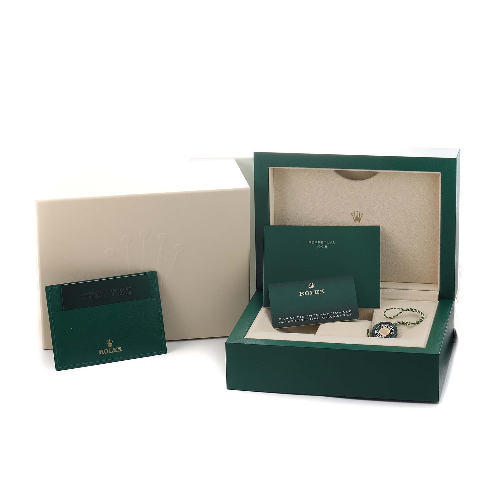 The Rolex 1908 52508 Men's Yellow Gold Black Dial watch is shown in its open box set with certificates and a warranty card.