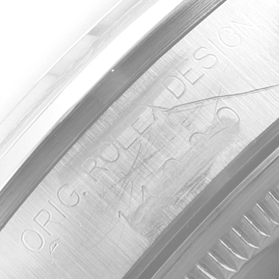 This image shows a close-up view of the engraved side of a Rolex Air-King 14000 Men's Stainless Steel Blue Dial 14000 Men's Stainless Steel Blue Dial watch casing with "ROLEX DESIGN" visible.