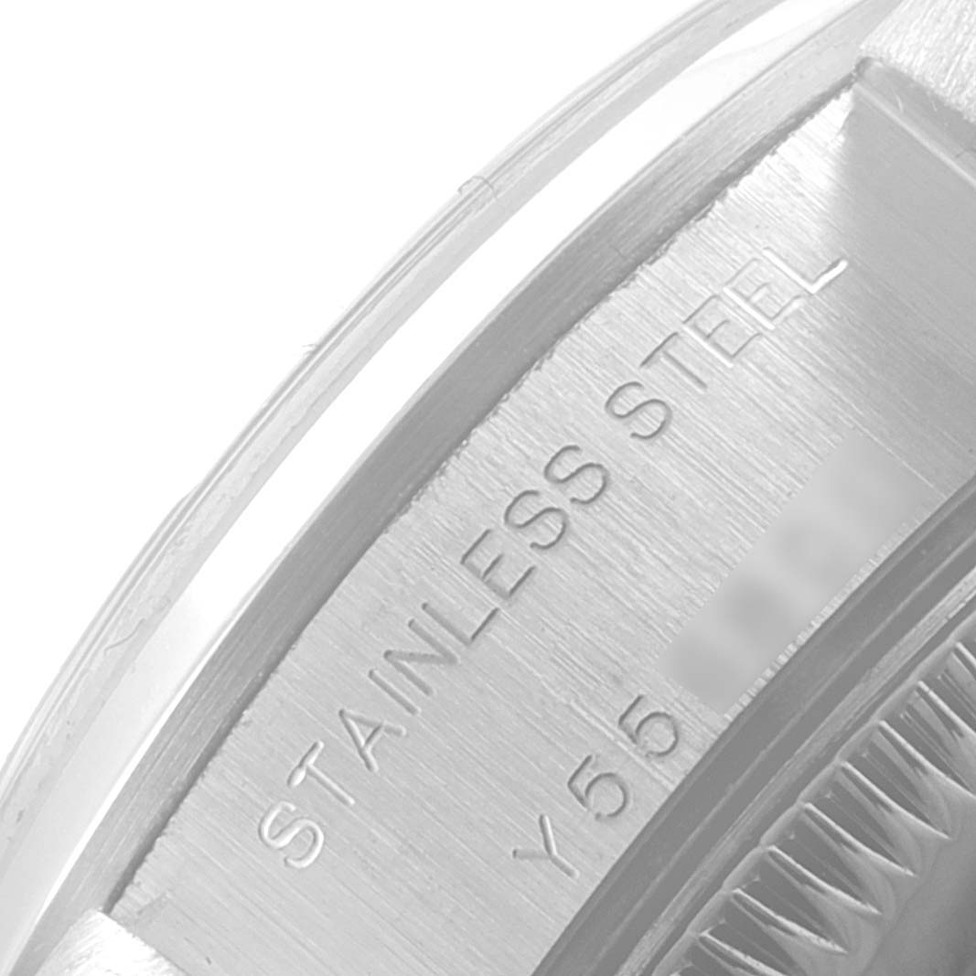 The image shows a close-up of the case engravings on a Rolex Date 79160 Women
s Stainless Steel Pink Dial 79160 Women
s Stainless Steel Pink Dial model watch, highlighting "STAINLESS STEEL".