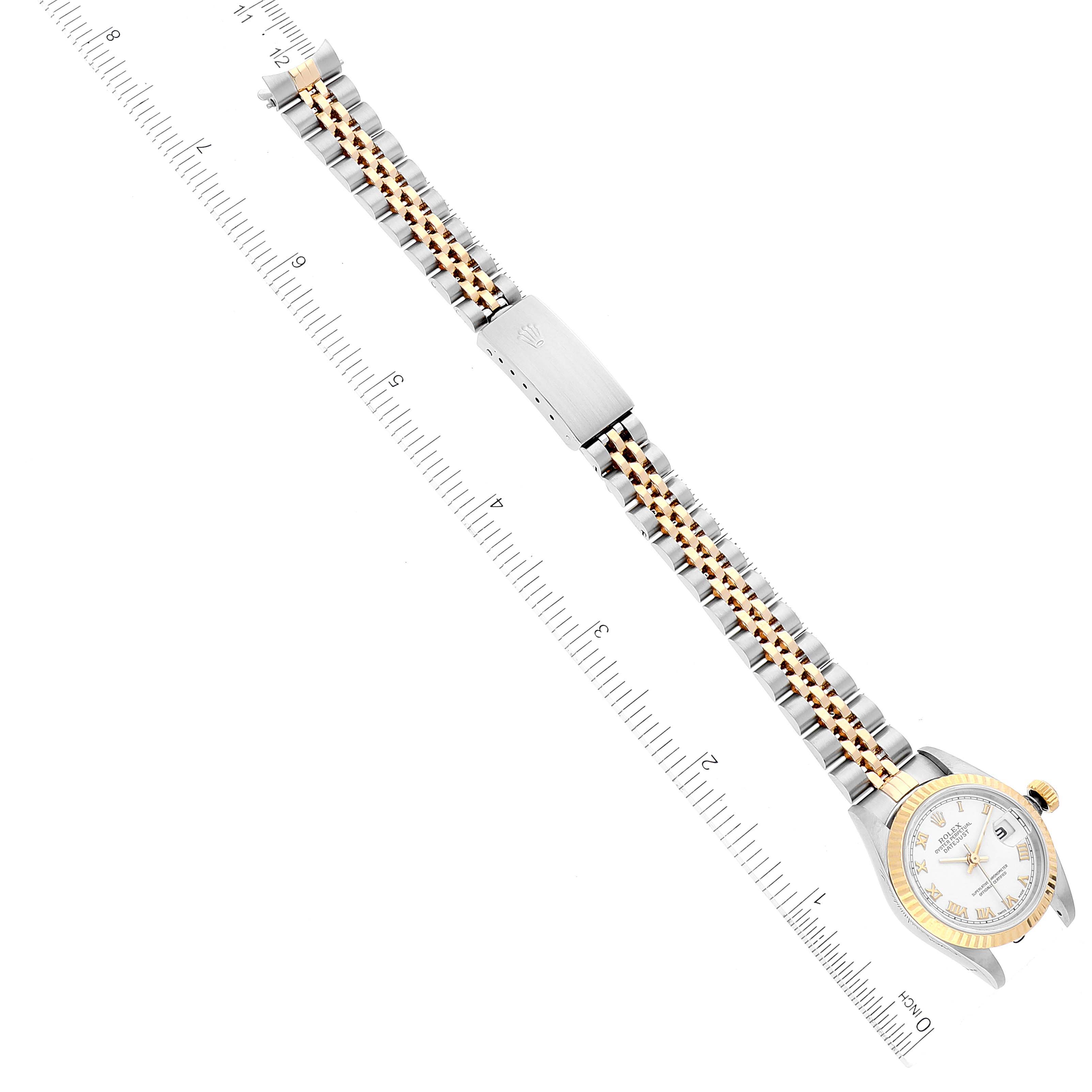 The image shows a Rolex Datejust 79173 Women's Steel and Gold (two tone) White Dial 79173 Women's Steel and Gold (two tone) White Dial watch laid flat alongside a ruler, displaying its face, case, and bracelet.
