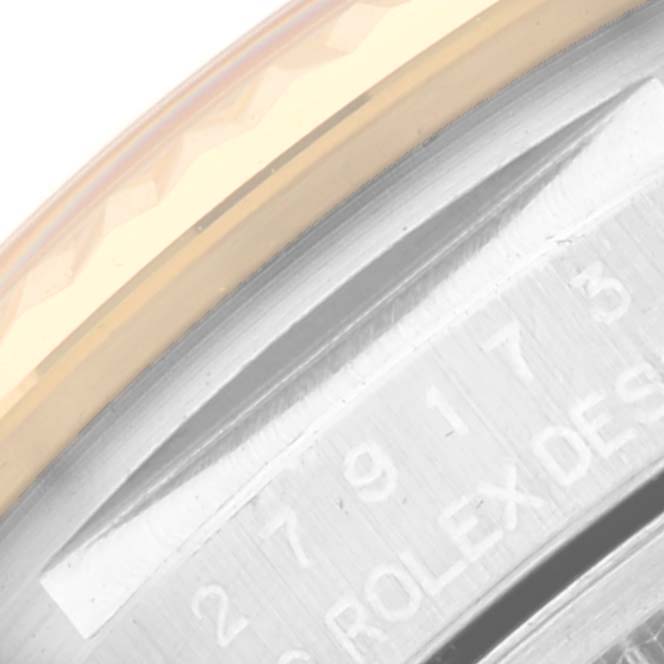 This close-up image shows the edge of the bezel and part of the engraved case back of a Rolex Datejust 279173 Women's Steel and Gold (two tone) Champagne Dial 279173 Women's Steel and Gold (two tone) Champagne Dial watch.