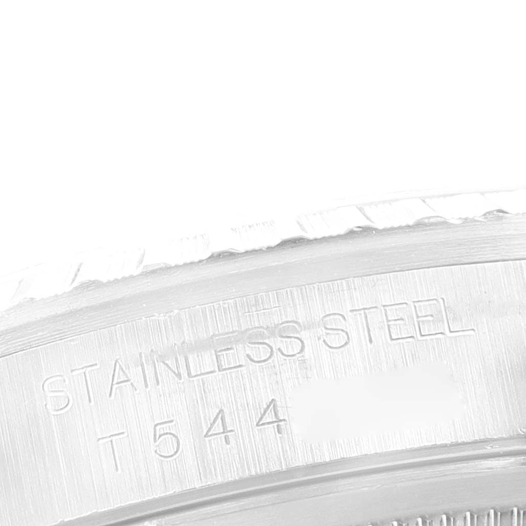 This image shows a close-up of the side of a stainless steel Rolex Datejust 16220 Men's Stainless Steel Pink Dial 16220 Men's Stainless Steel Pink Dial watch case, with part of the serial number visible.