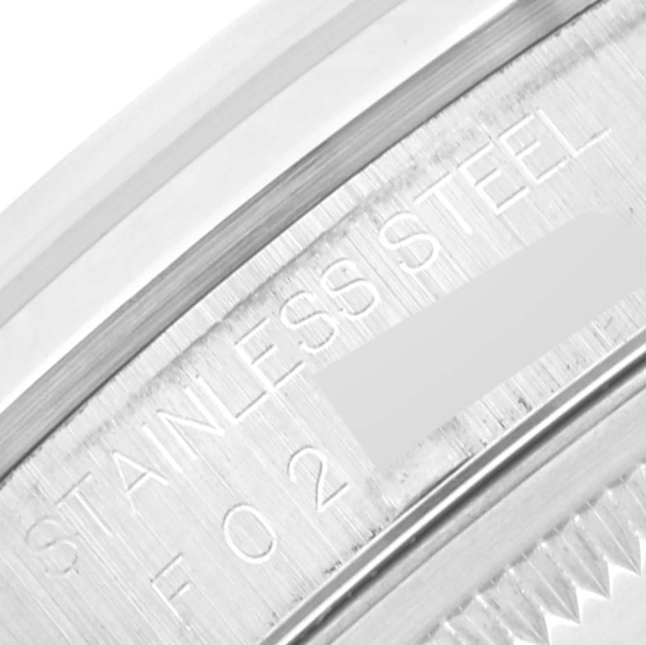 This image shows a close-up of the engravings on the outer rim of a Rolex Datejust 16200 Men's Stainless Steel Silver Dial 16200 Men's Stainless Steel Silver Dial watch caseback, highlighting the text "STAINLESS STEEL.”