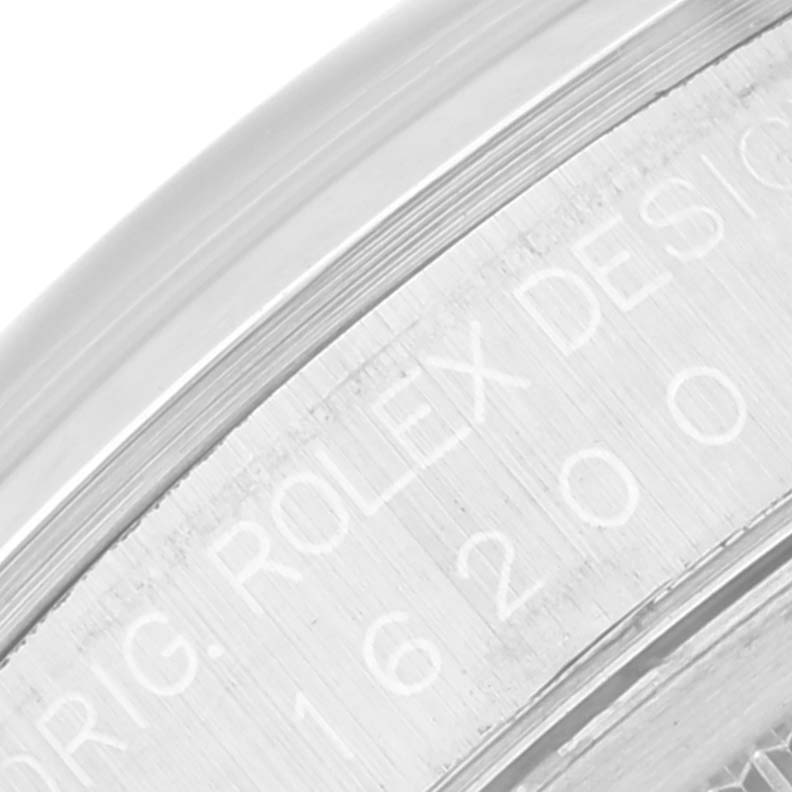 This close-up image shows the engraved inner rim of a Rolex Datejust 16200 Men's Stainless Steel Silver Dial 16200 Men's Stainless Steel Silver Dial watch, highlighting part of the brand's name.