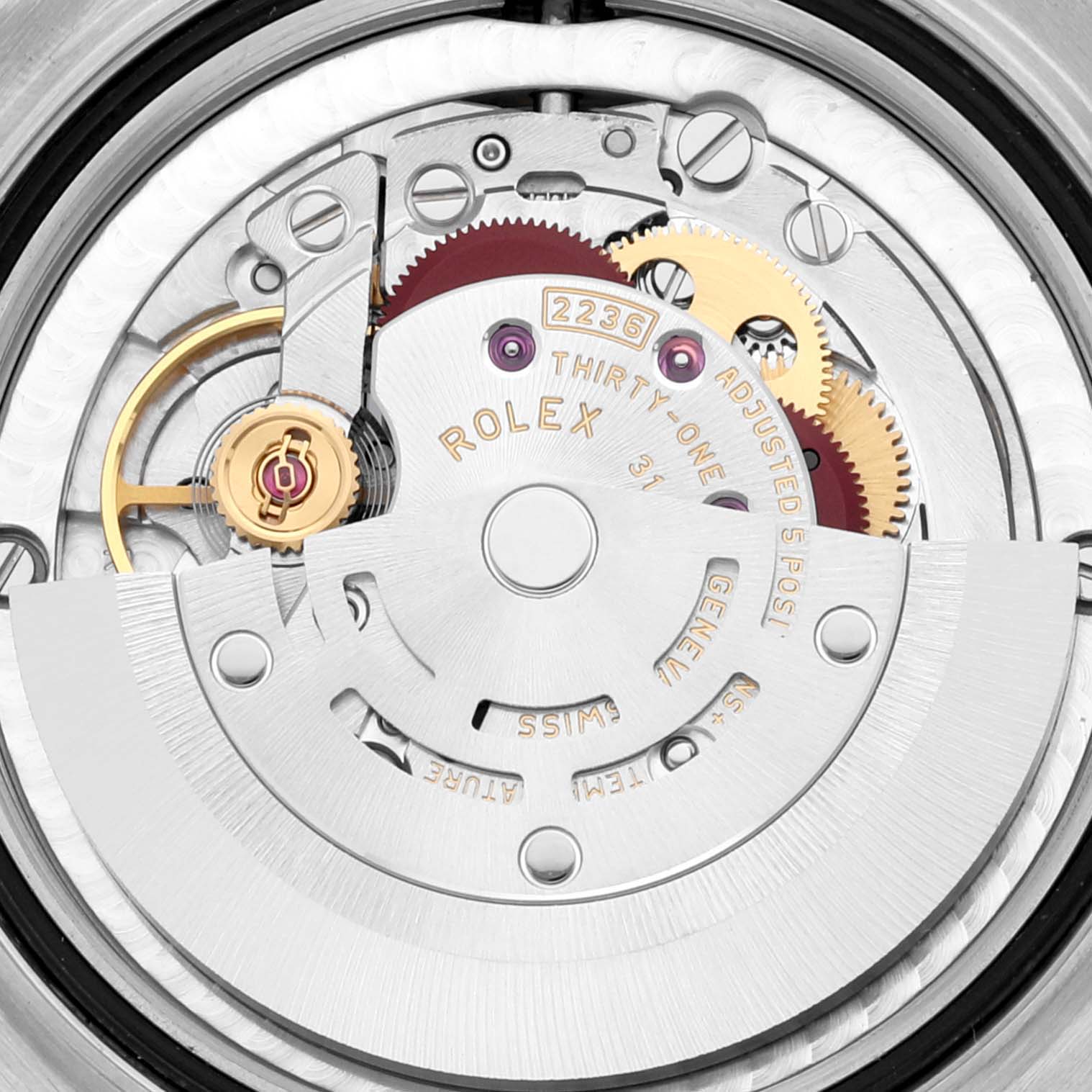 This image shows a close-up view of the inner mechanical movement of a Mid-Size Rolex watch, highlighting gears and the rotor.