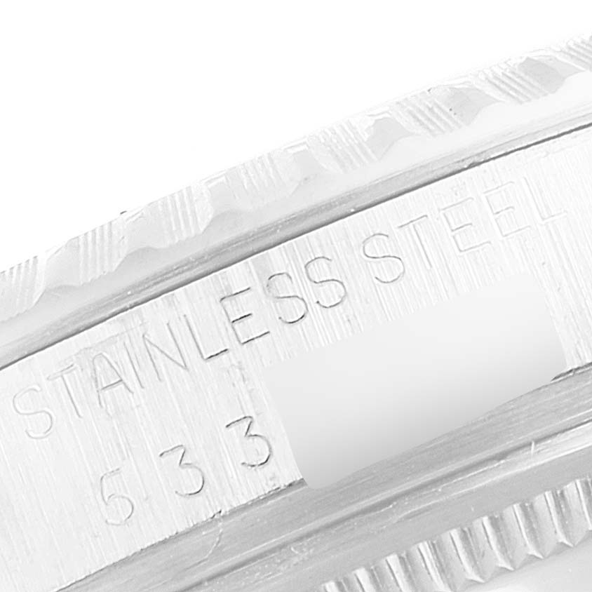 This close-up image shows the side of the bezel and part of the case with "STAINLESS STEEL 633" engraved on a Rolex Vintage Collection 1603 Men's Stainless Steel Silver Dial 1603 Men's Stainless Steel Silver Dial model.