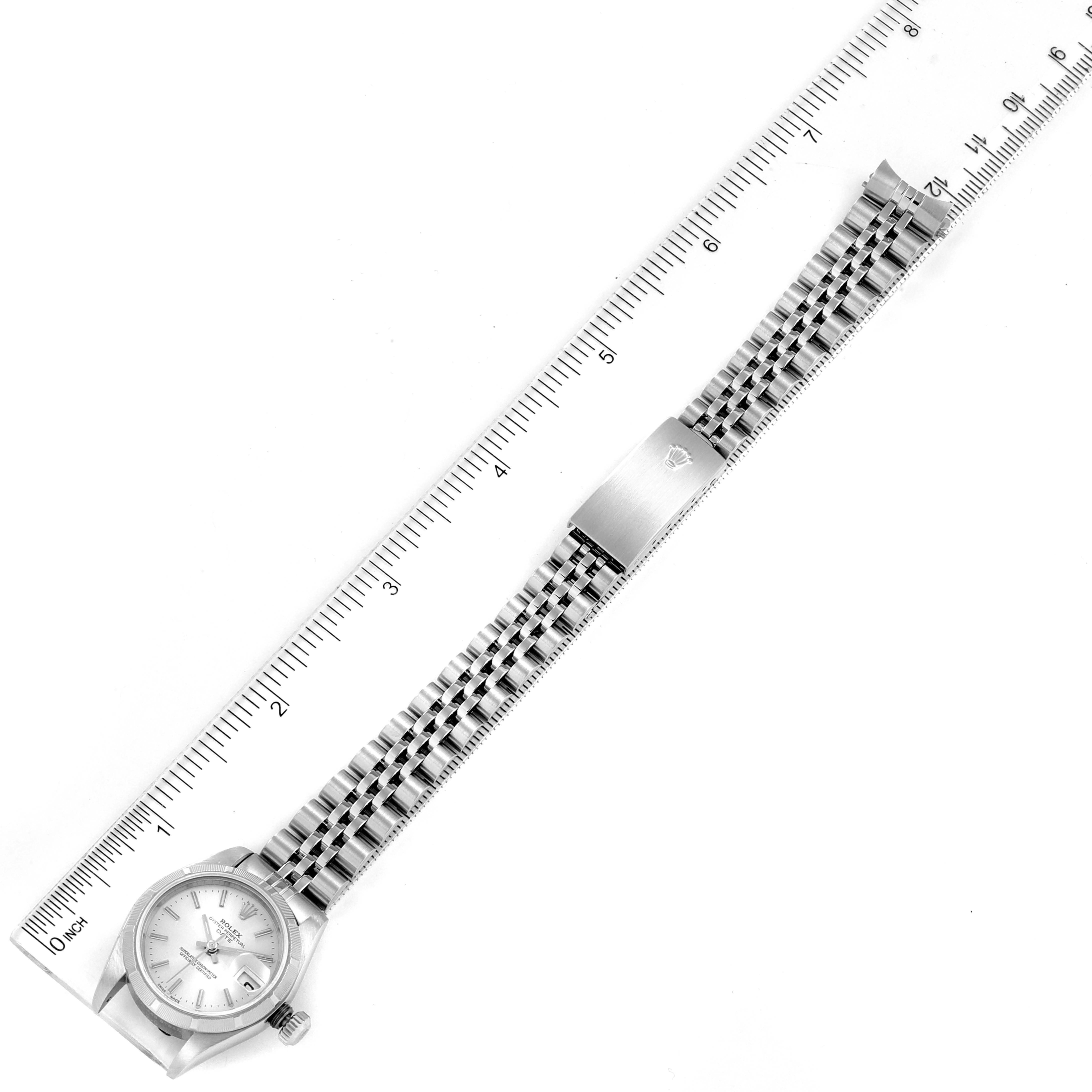 The image shows a top-down view of a Rolex Date 79190 Women's Stainless Steel Silver Dial 79190 Women's Stainless Steel Silver Dial model watch with its full bracelet laid out beside a measuring ruler.