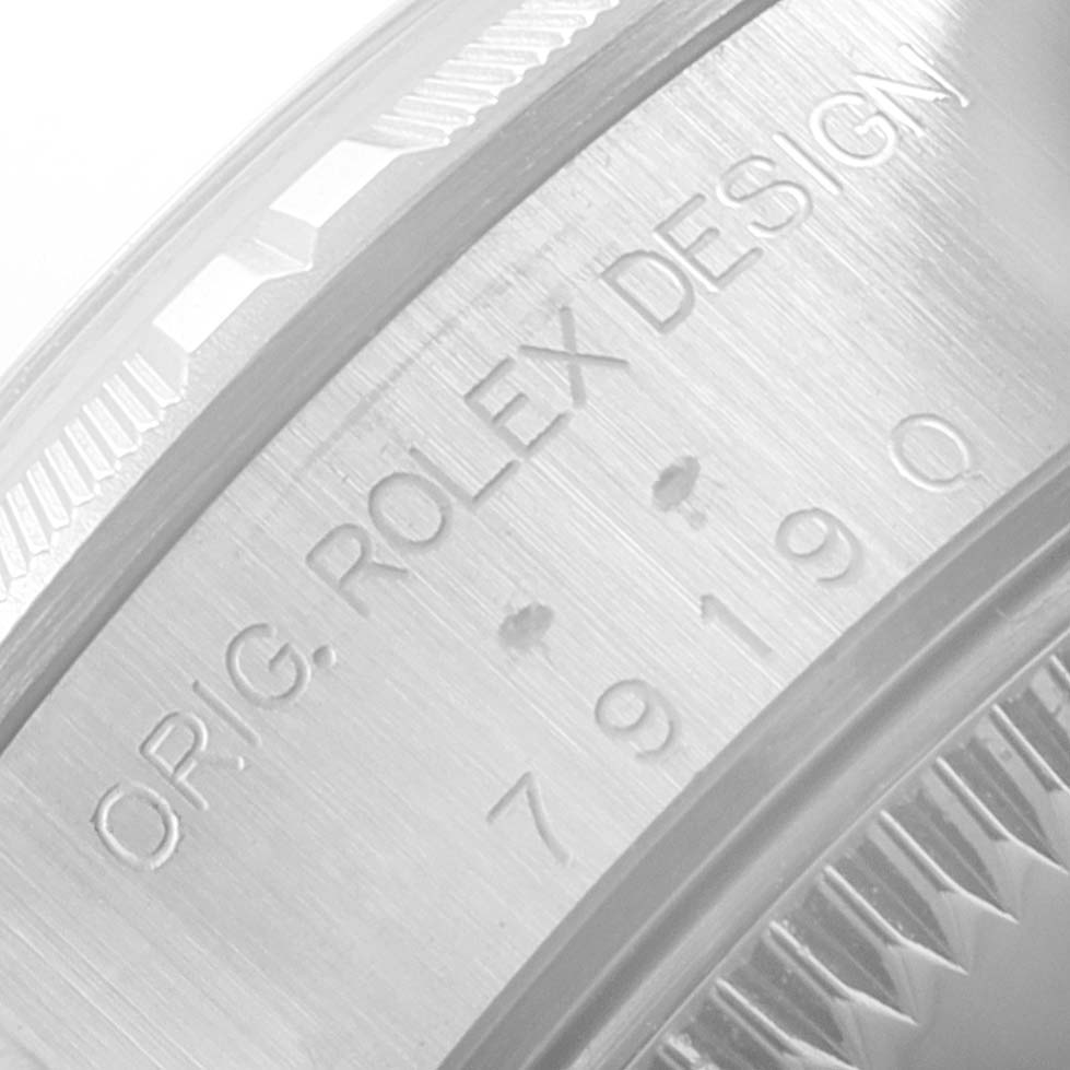 This image shows a close-up of the side casing, including the serial number engraving on a Rolex Date 79190 Women's Stainless Steel Silver Dial 79190 Women's Stainless Steel Silver Dial model watch.