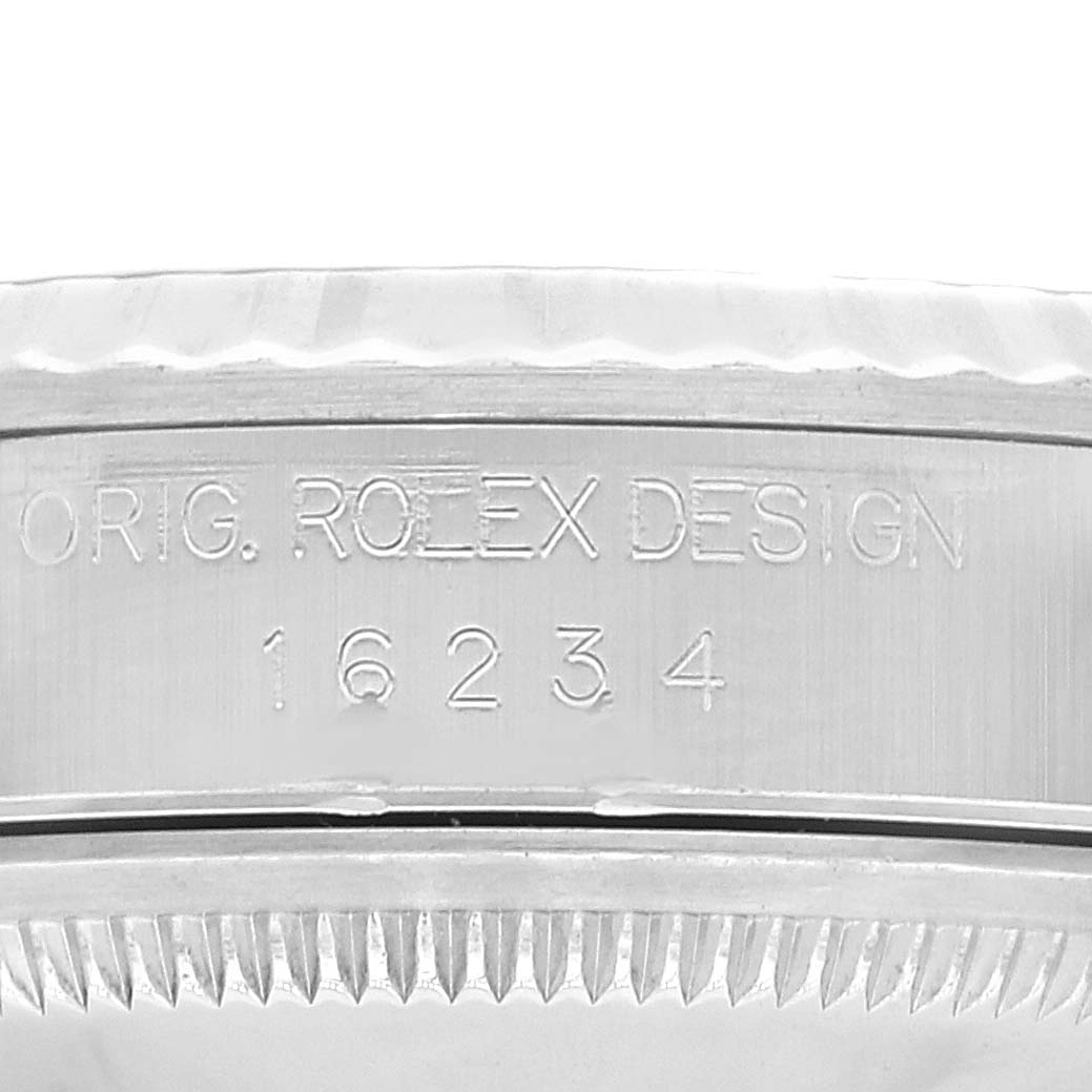 The image shows an angled close-up of the engraved side and fluted bezel of a Rolex Datejust 16234 Men's Stainless Steel Black Dial 16234 Men's Stainless Steel Black Dial model 16234.
