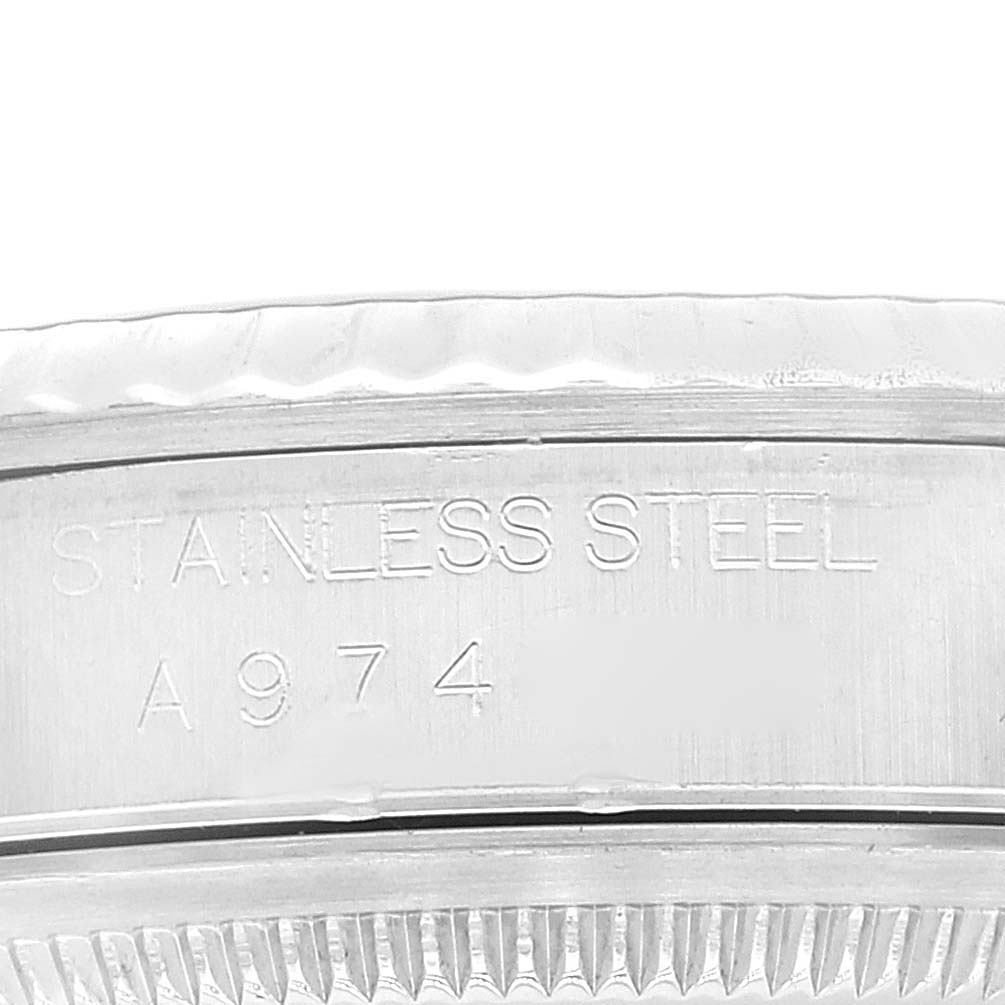 This image shows an up-close view of the rim and some engravings on the bezel of a Rolex Datejust 16234 Men's Stainless Steel Black Dial 16234 Men's Stainless Steel Black Dial watch.