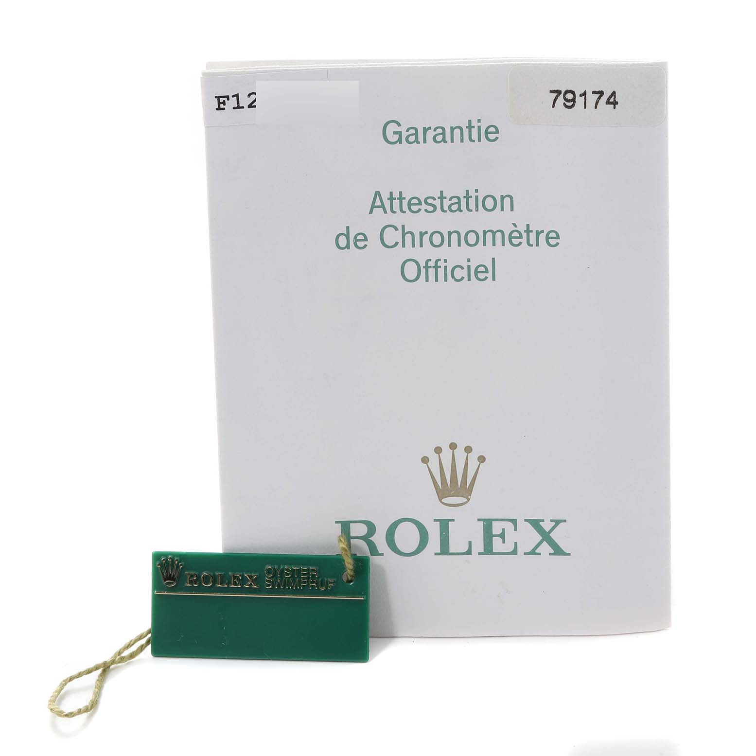 The image shows a warranty booklet and a green tag for the Rolex Datejust 79174 Women's Stainless Steel White Dial 79174 Women's Stainless Steel White Dial model, viewed from the front.