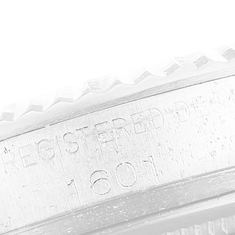 This close-up image of the Rolex Vintage Collection 1601 Men's Stainless Steel Silver Dial 1601 Men's Stainless Steel Silver Dial model 1601 showcases the engraved bezel and part of the case side.