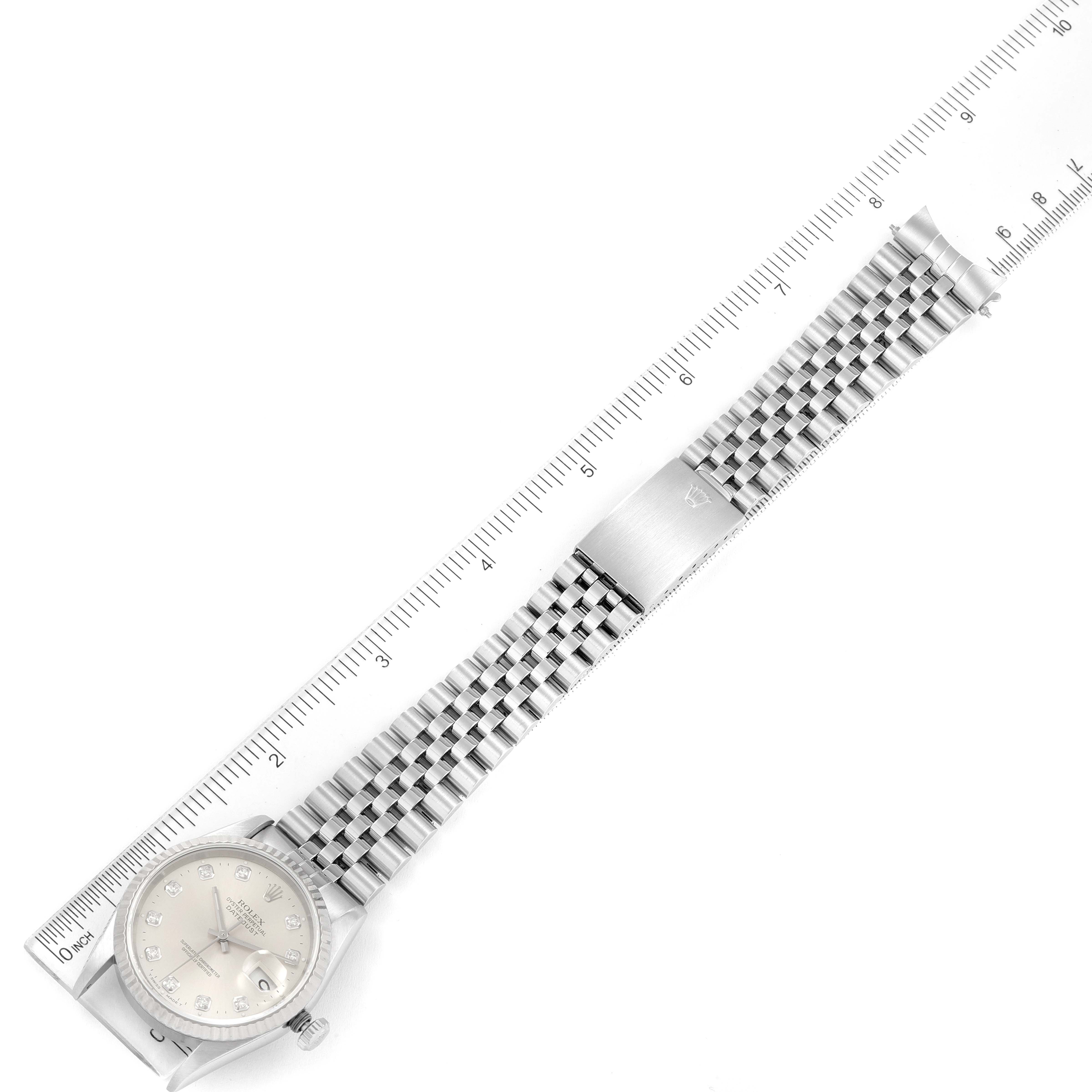 This image shows a Rolex Datejust 16234 Men's Stainless Steel Silver Dial 16234 Men's Stainless Steel Silver Dial watch laid flat with a ruler for scaling, displaying the dial and metal bracelet.