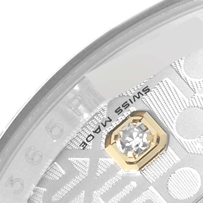 This close-up of the Rolex Datejust 116243 Men's Steel and Gold (two tone) Silver Dial 116243 Men's Steel and Gold (two tone) Silver Dial shows part of the dial with a diamond-set hour marker and the "Swiss Made" inscription.