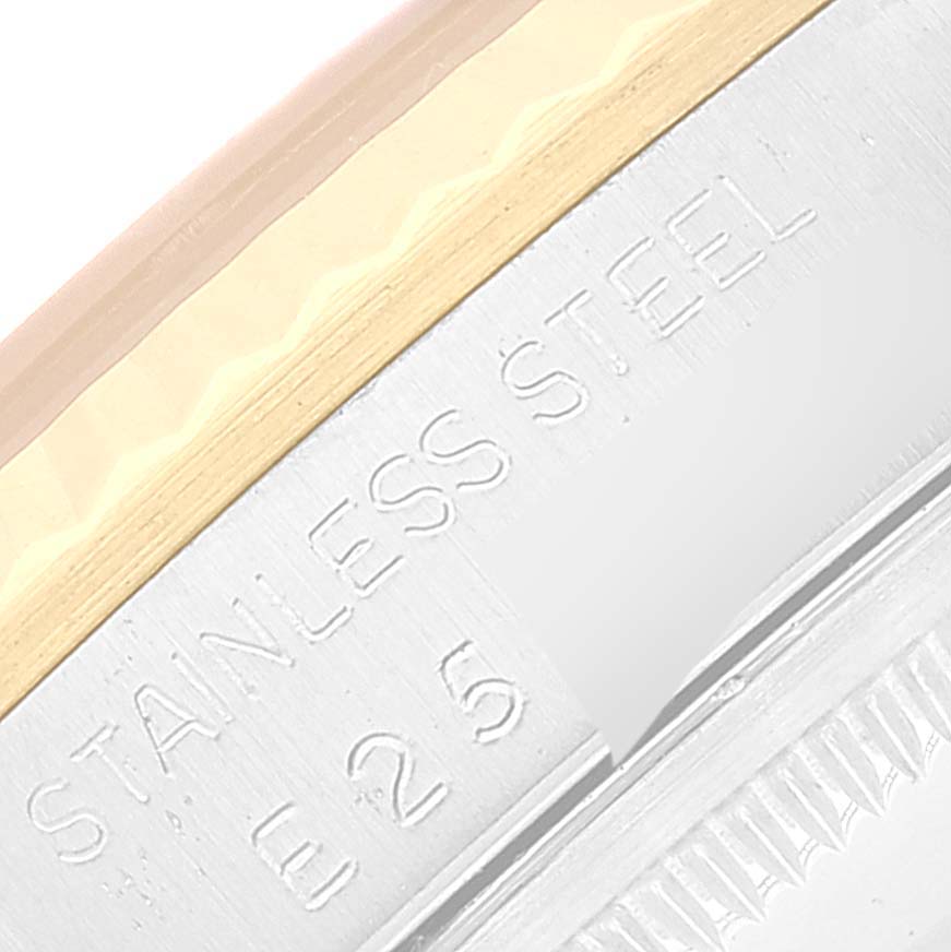 This close-up image shows the edge and engraving of a Rolex Datejust 16233 Men's Steel and Gold (two tone) Champagne Dial 16233 Men's Steel and Gold (two tone) Champagne Dial watch case, displaying "Stainless Steel E25."
