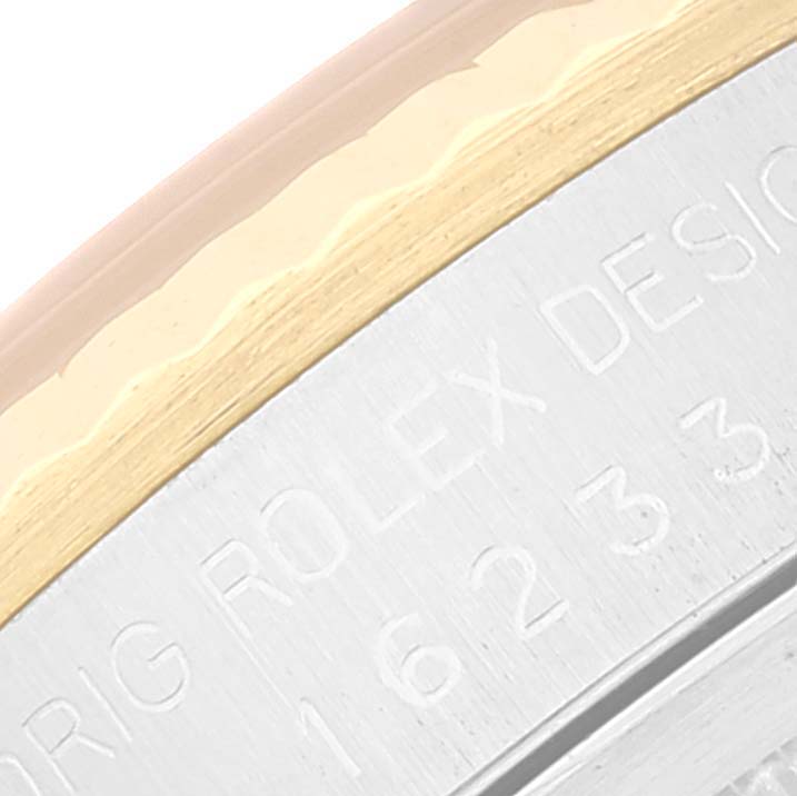 The image shows an angled close-up of the side engraving and bezel part of a Rolex Datejust 16233 Men's Steel and Gold (two tone) Champagne Dial 16233 Men's Steel and Gold (two tone) Champagne Dial watch.