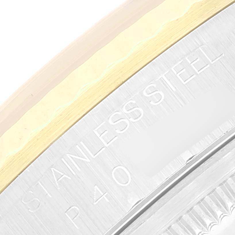 This image shows a close-up of the stainless steel case back and part of the bezel of a Rolex Datejust 16233 Men's Steel and Gold (two tone) White Dial 16233 Men's Steel and Gold (two tone) White Dial watch.