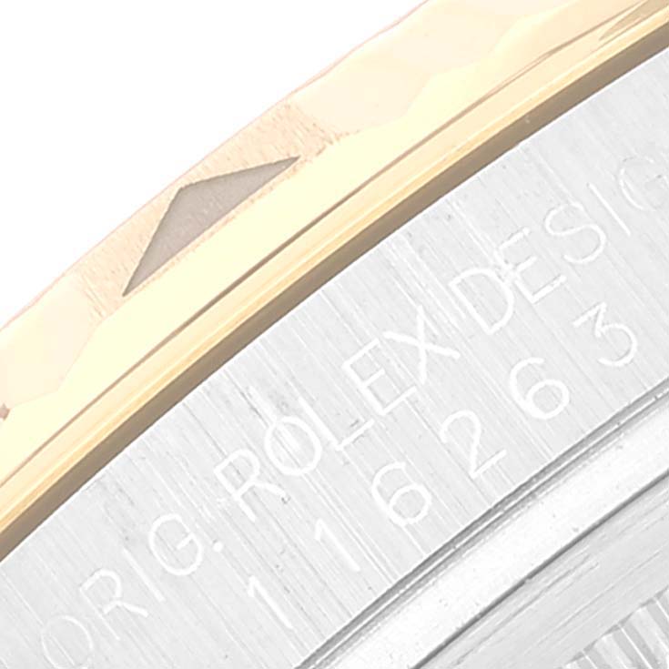The image shows a close-up angle of the case and bezel of a Rolex Turn-o-Graph 116263 Men's Steel and Gold (two tone) White Dial 116263 Men's Steel and Gold (two tone) White Dial watch, including engraved text. 
