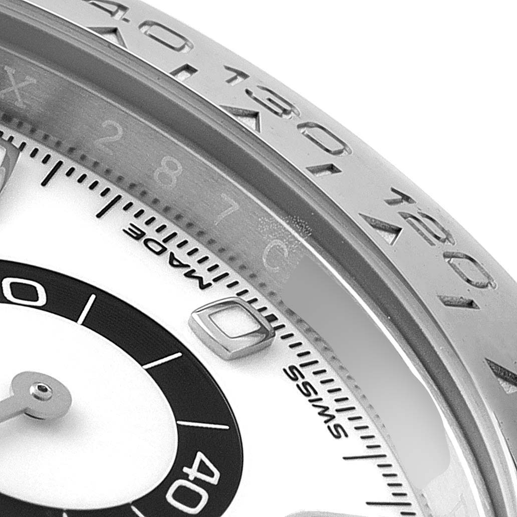 This image shows a close-up of the bezel and part of the dial of a Rolex Daytona 116500 Men's Stainless Steel White Dial 116500 Men's Stainless Steel White Dial watch, highlighting the tachymeter markings.