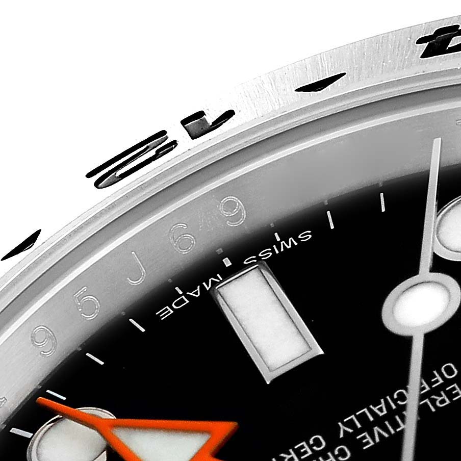 This image shows a close-up angle of the bezel, dial, and part of the hands of the Rolex Explorer 216570 Men's Stainless Steel Black Dial 216570 Men's Stainless Steel Black Dial watch.
