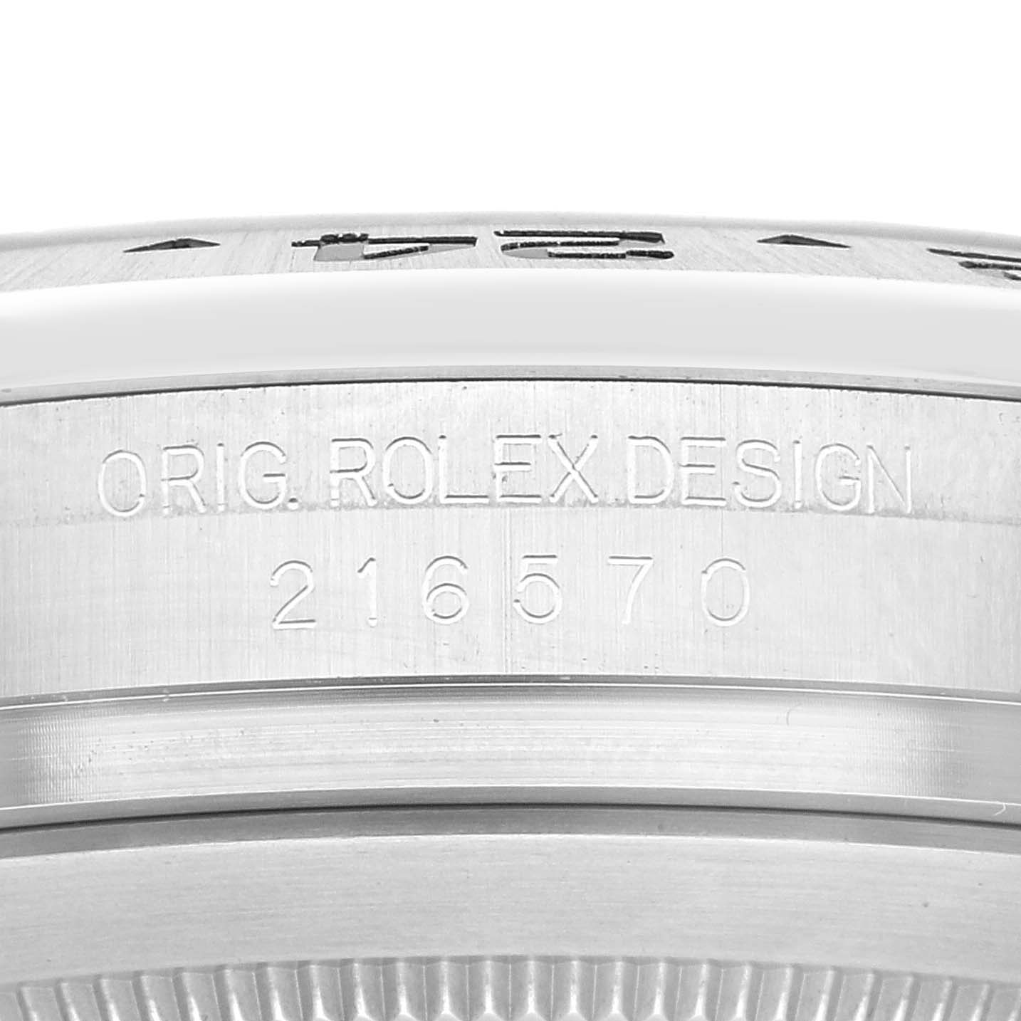 The image shows the side of a Rolex Explorer 216570 Men's Stainless Steel Black Dial 216570 Men's Stainless Steel Black Dial model with the serial number "216570" and "Orig. Rolex Design" engraved.