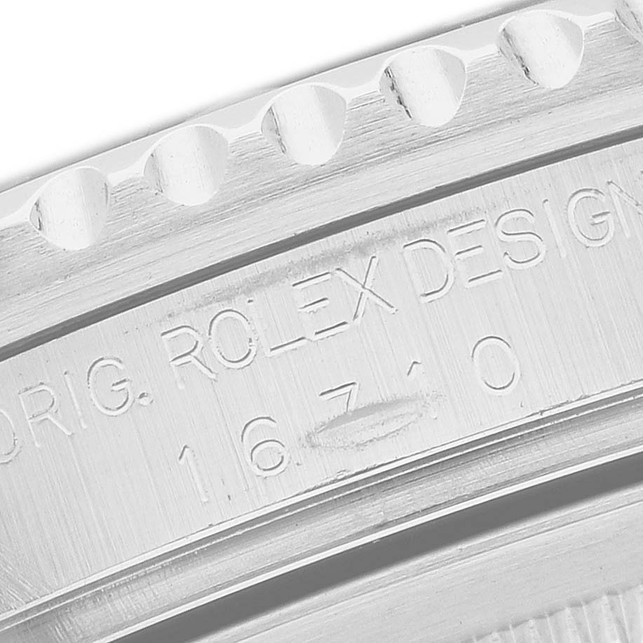 The image shows a close-up of the model number engraving and bezel edge on a Rolex GMT-Master 16710 Men's Stainless Steel Black Dial watch.