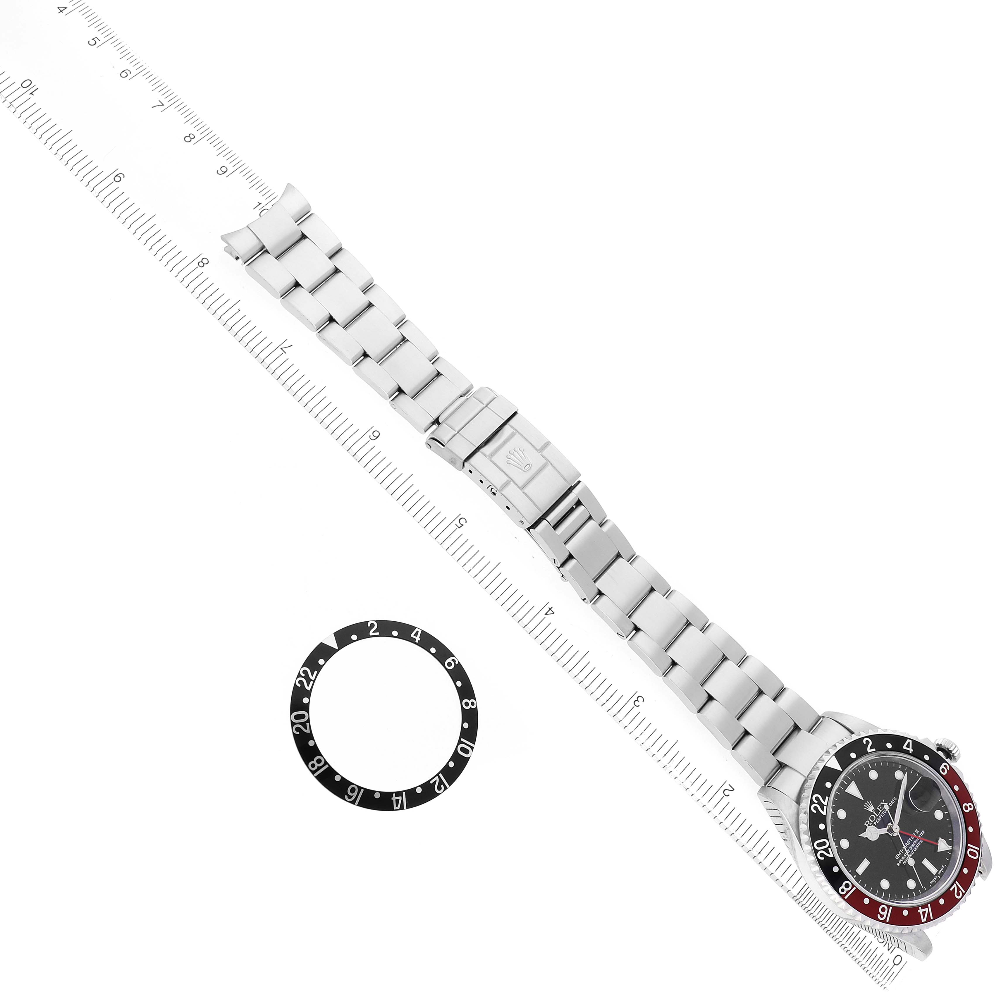 The Rolex GMT-Master 16710 Men's Stainless Steel Black Dial watch is shown from a top view, displaying the full bracelet and bezel insert separately.