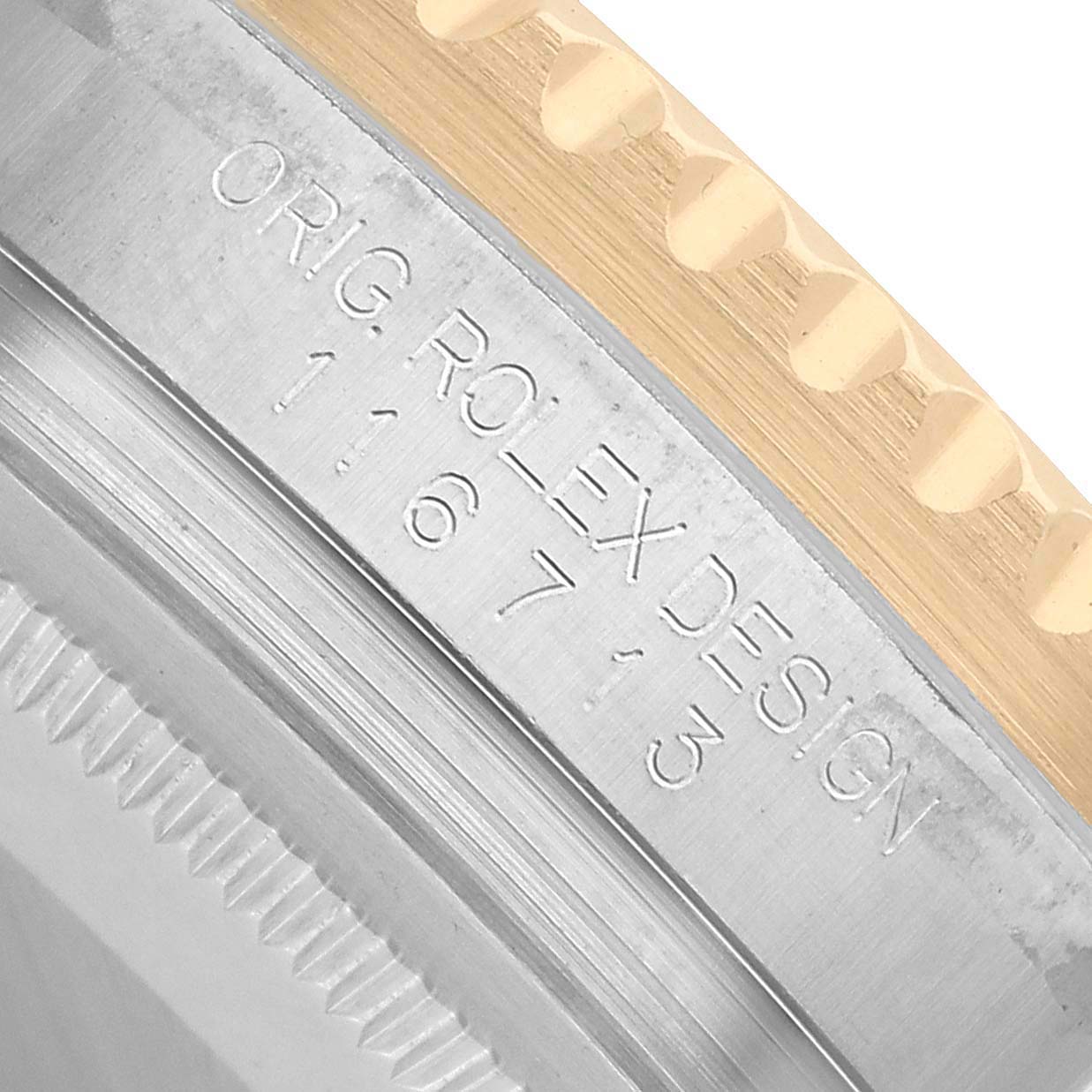 The image shows a close-up of the side engraving on the bezel of a Rolex GMT-Master 116713 Men's Steel and Gold (two tone) Black Dial, showcasing the model number and design details.