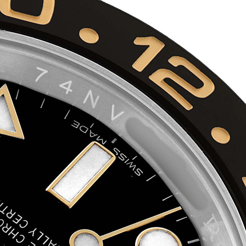 The image shows a close-up angle of the Rolex GMT-Master 116713 Men's Steel and Gold (two tone) Black Dial's bezel and dial, focusing on the numbers and markers.