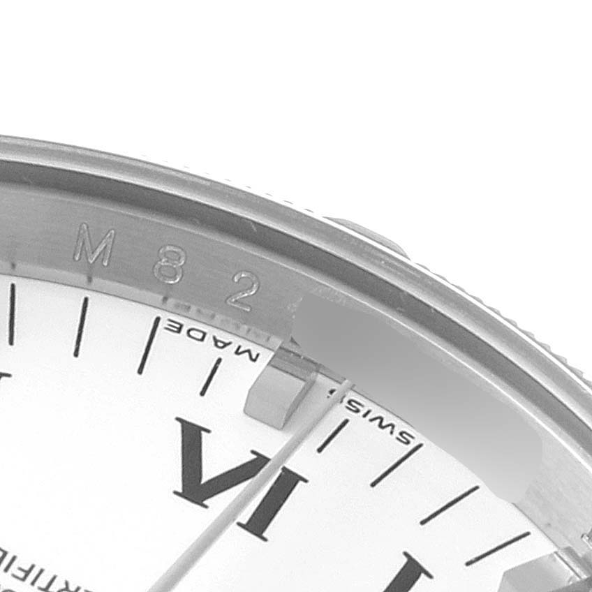 This close-up shows the edge of the dial, bezel, and part of the casing of a Rolex Air-King 114210 Men's Stainless Steel White Dial 114210 Men's Stainless Steel White Dial watch.