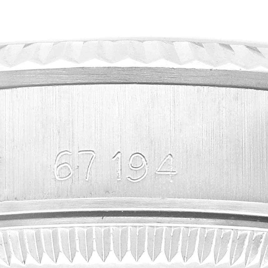 This image shows a close-up view of the case side and bezel of a Rolex Oyster Perpetual 67194 Women's Stainless Steel Blue Dial 67194 Women's Stainless Steel Blue Dial, featuring engraved numbers.