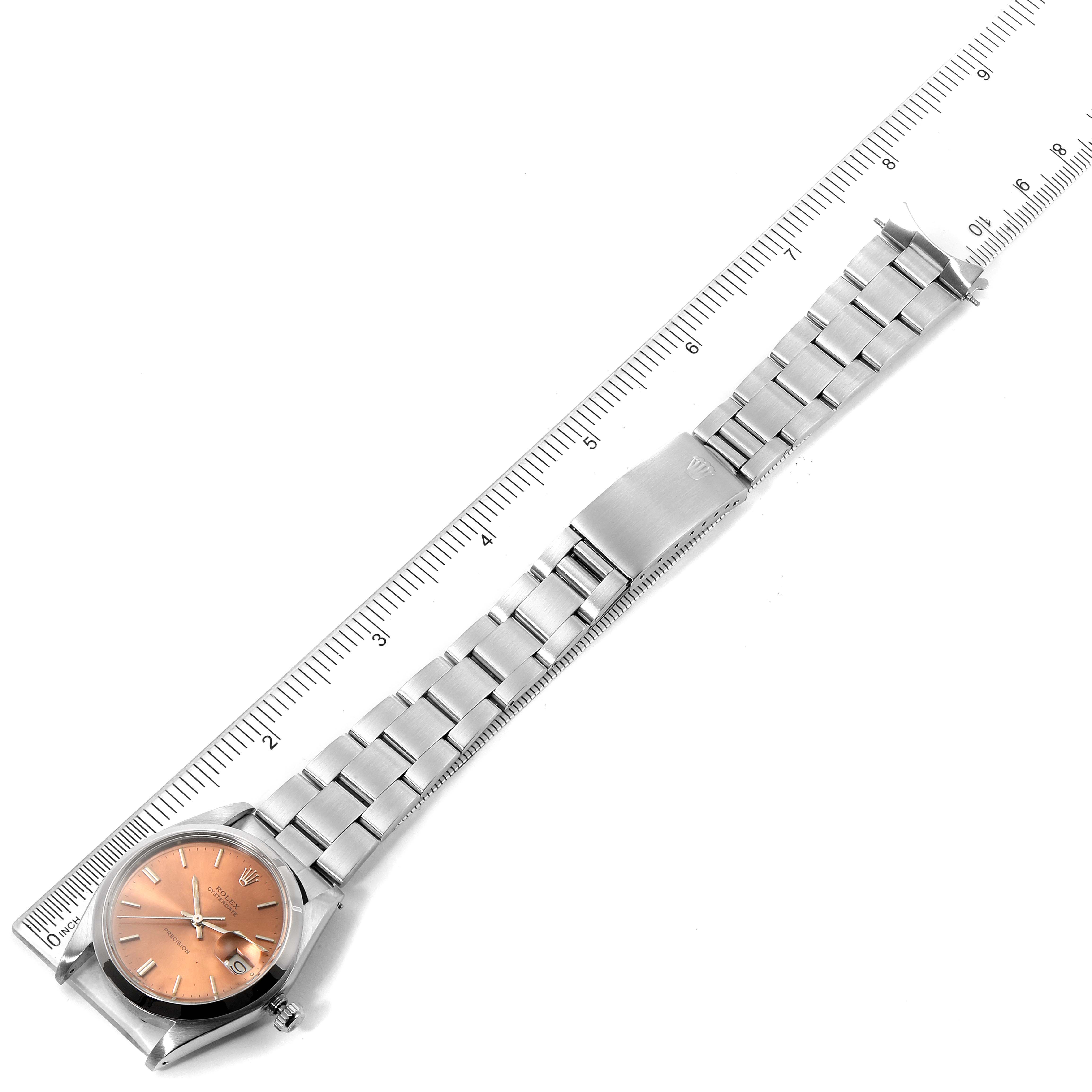 The image shows a Rolex Vintage Collection 6694 Men's Stainless Steel Brown Dial 6694 Men's Stainless Steel Brown Dial watch laid flat beside a ruler, highlighting its dial, bracelet, and clasp.