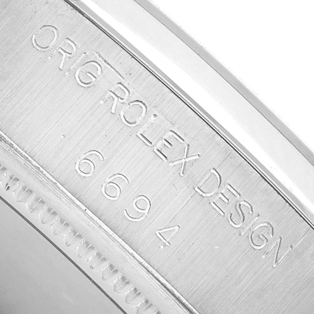 The image shows a close-up of the inner case engraving, featuring "ORIG ROLEX DESIGN 6694" on the Vintage Collection Rolex watch.
