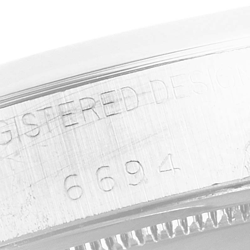 The image shows an engraved part of the case of a Vintage Collection model by Rolex, viewed from a close-up angle.