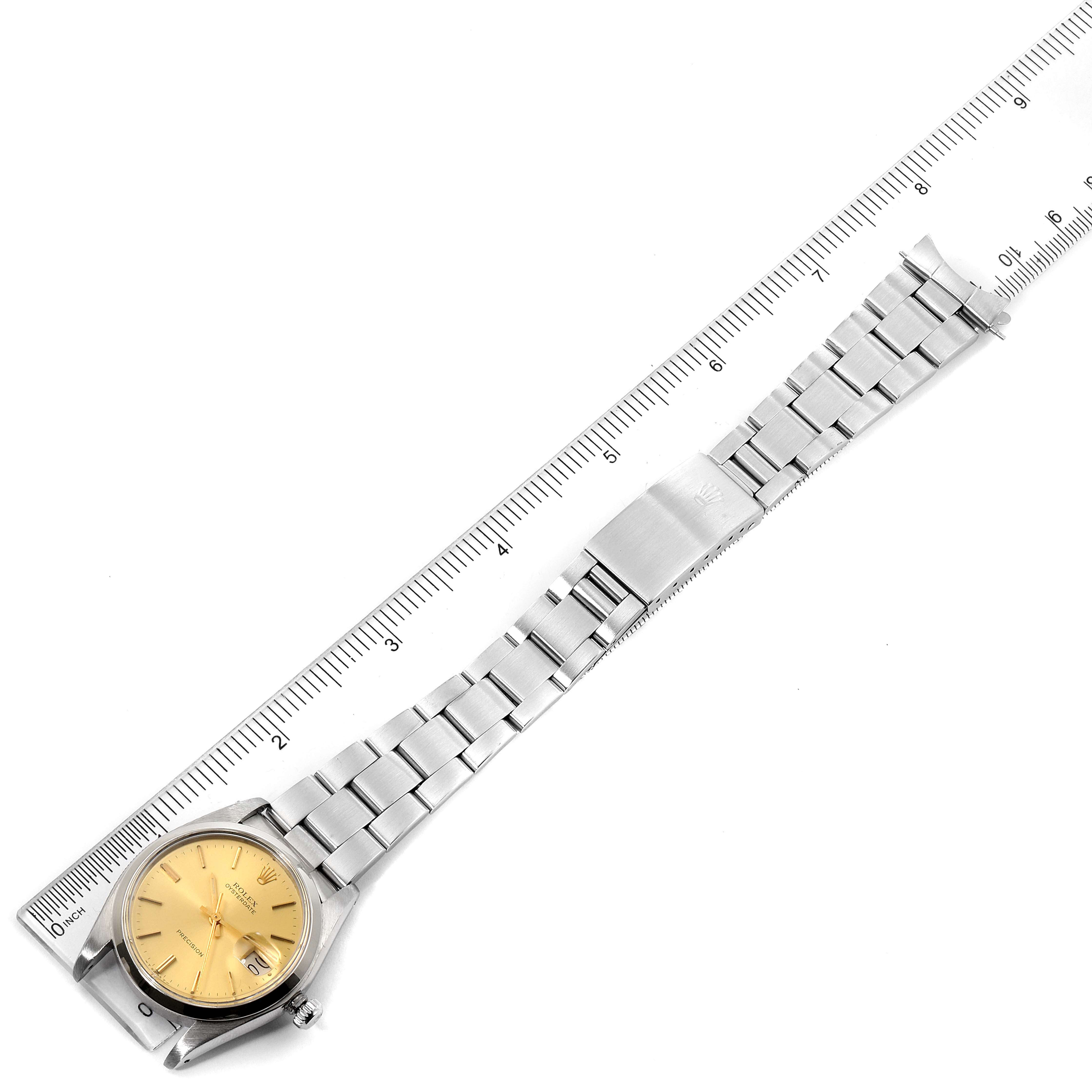 This image shows a top view of a Rolex Vintage Collection 6694 Men's Stainless Steel Champagne Dial 6694 Men's Stainless Steel Champagne Dial watch with its bracelet laid next to a ruler.