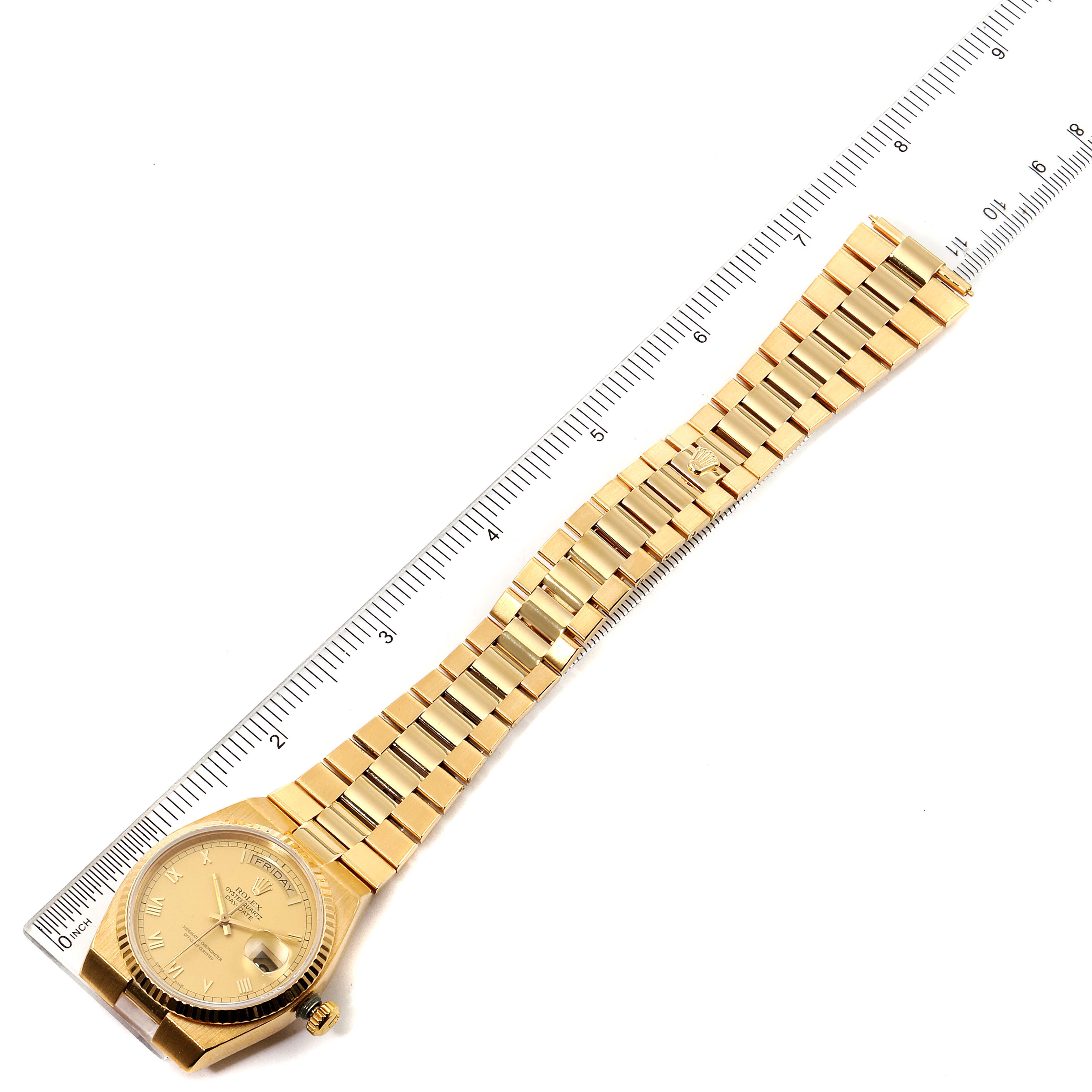 The image shows a top view of a gold Rolex Oysterquartz 19018 Men's Yellow Gold Champagne Dial 19018 Men's Yellow Gold Champagne Dial watch laid flat next to a ruler.