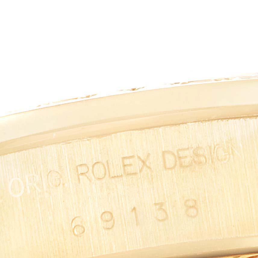 This image shows a close-up of the inner case of the Rolex President 69138G Women
s Yellow Gold Champagne Dial 69138G Women
s Yellow Gold Champagne Dial model, displaying the model number 69138 and "ORIG. ROLEX DESIGN".