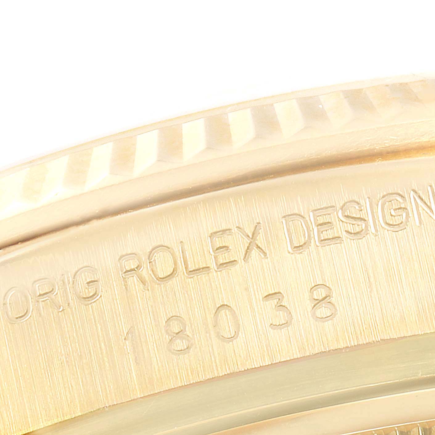 The image shows a close-up of the Rolex President 18038 Men's Yellow Gold Champagne Dial 18038 Men's Yellow Gold Champagne Dial model's bezel and case edge, highlighting the engravings.
